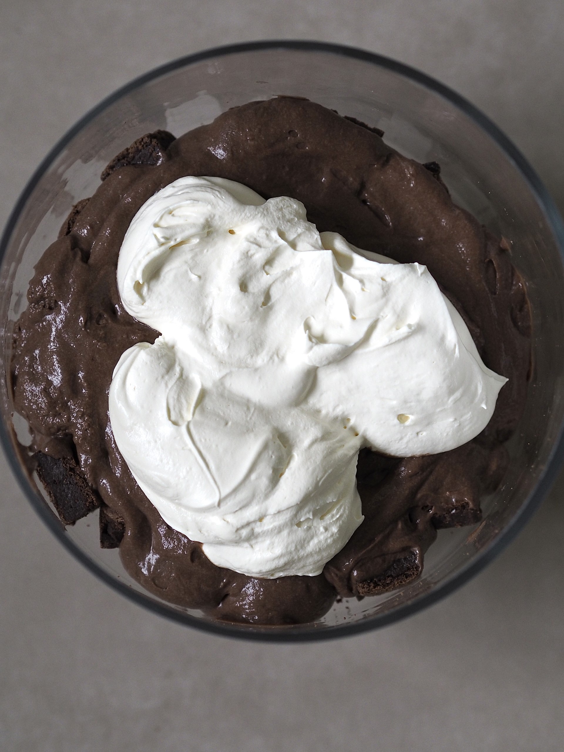 Layering Chocolate Trifle with whipped cream