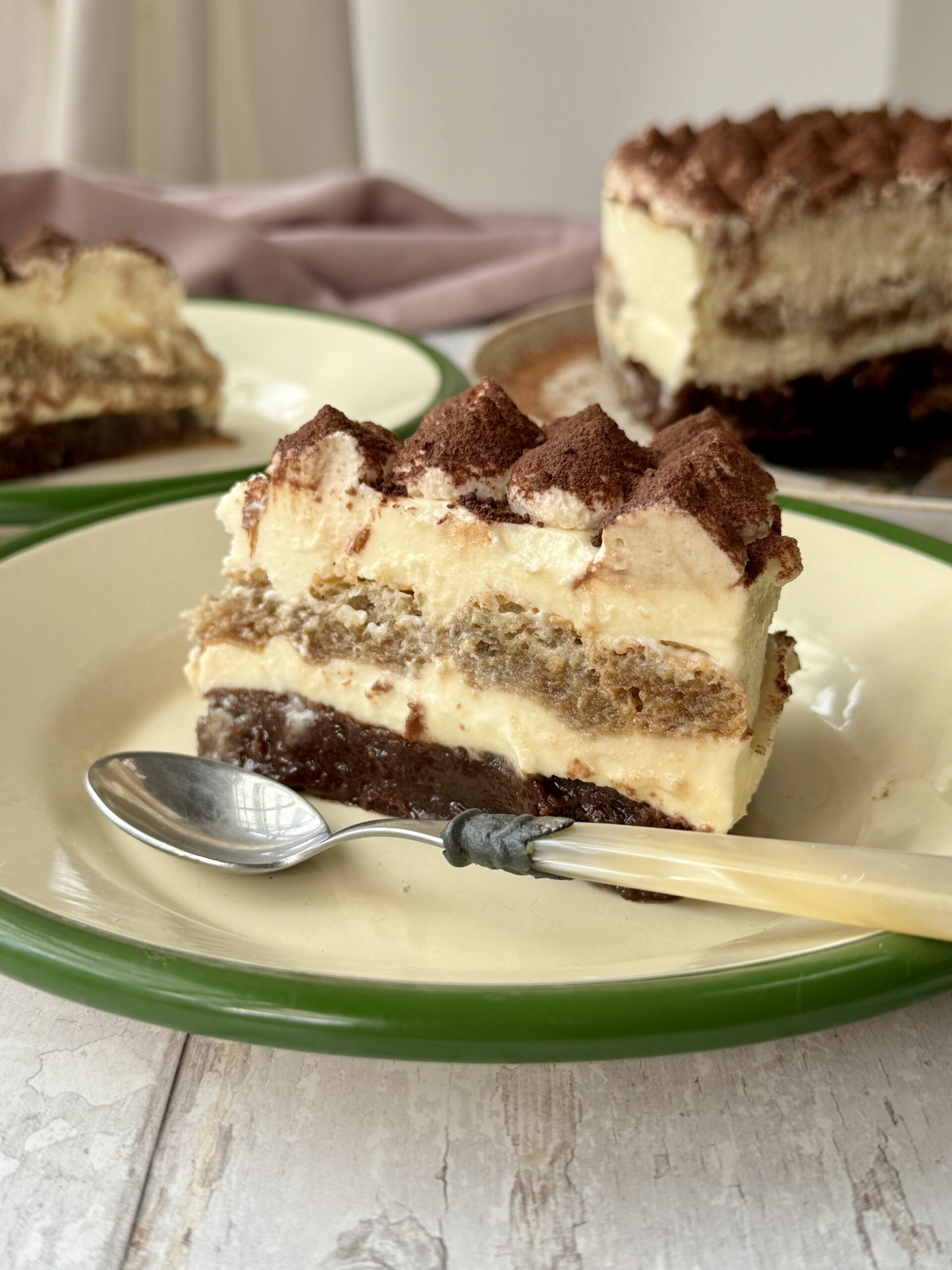 tiramisu cheesecake slice on a plate