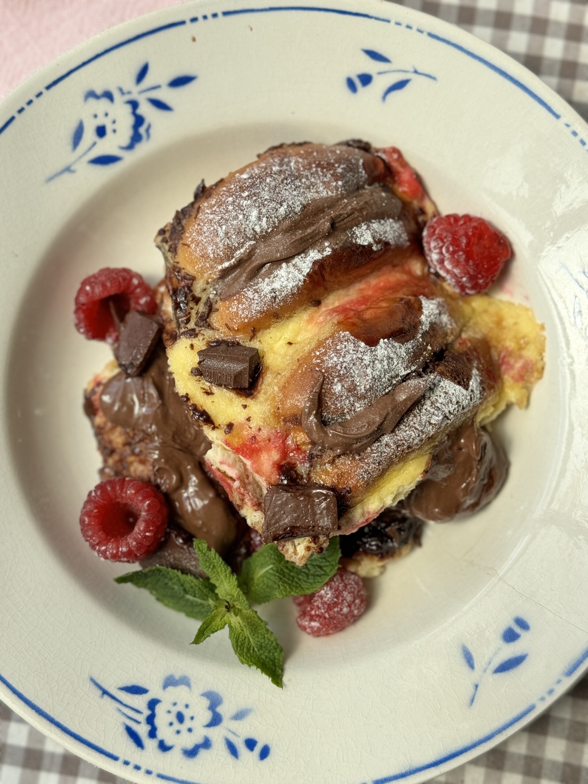 a portion of bread and brioche pudding on plate with blue flowers