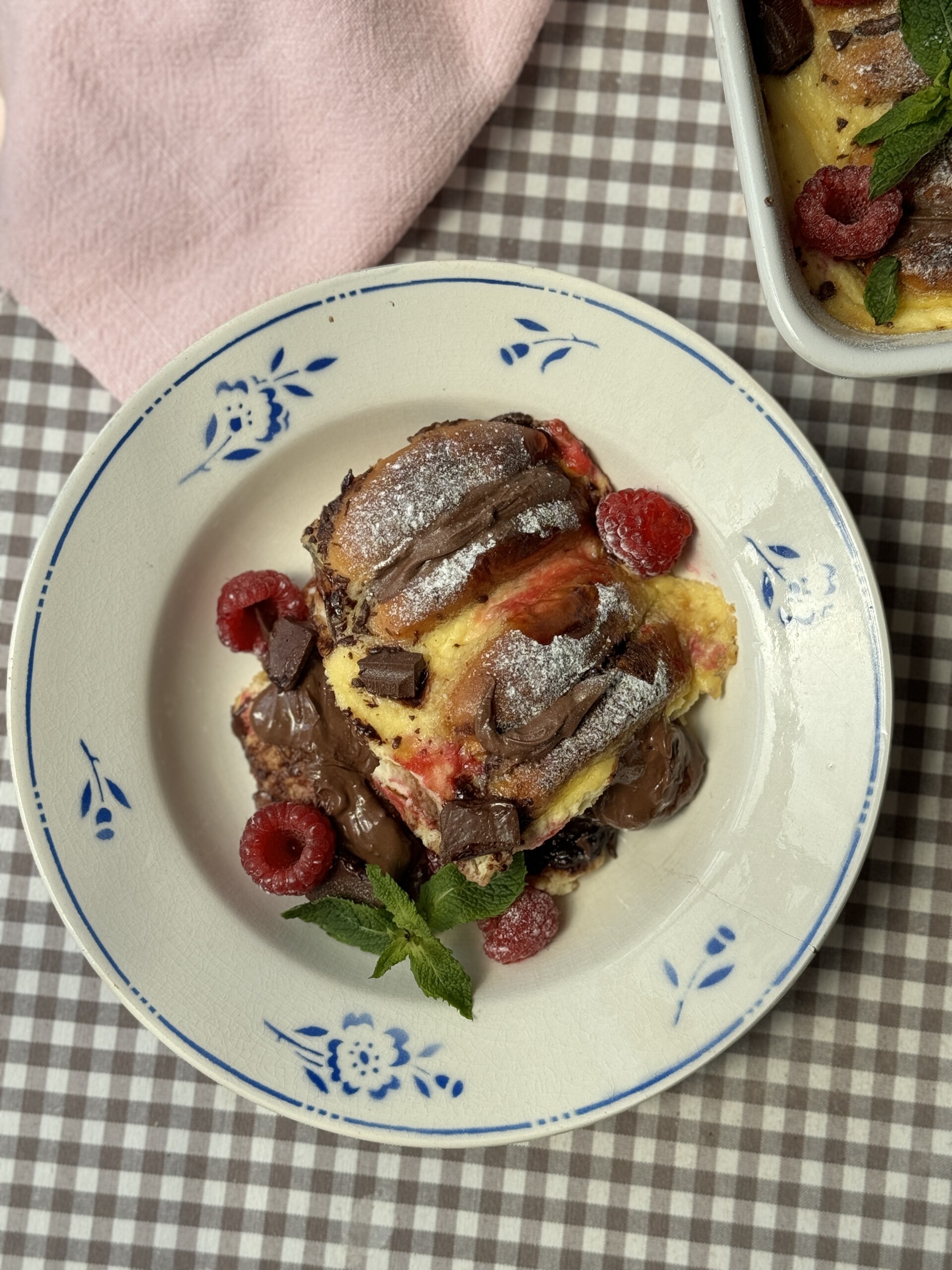 a portion of bread and brioche pudding on plate with blue flowers