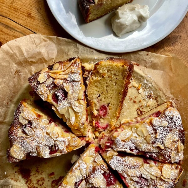 sliced Raspberry Almond and Ricotta Cake on a plate.