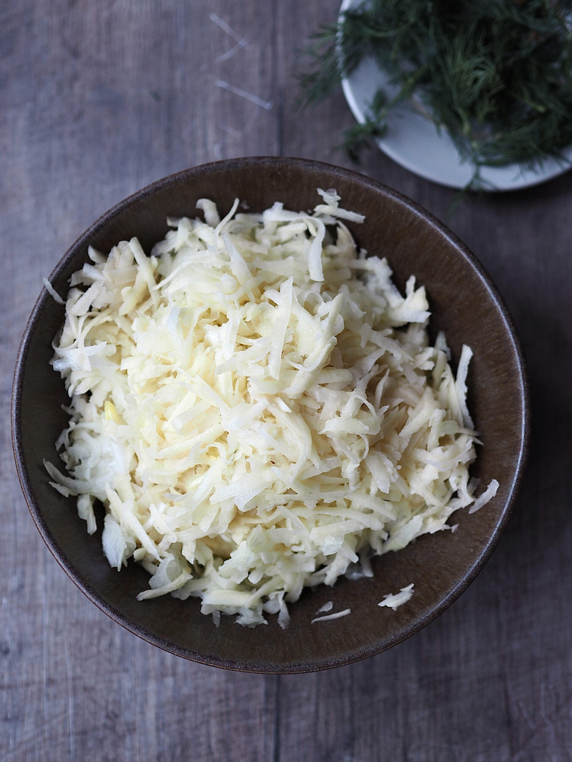 Grating the potatoes and onions