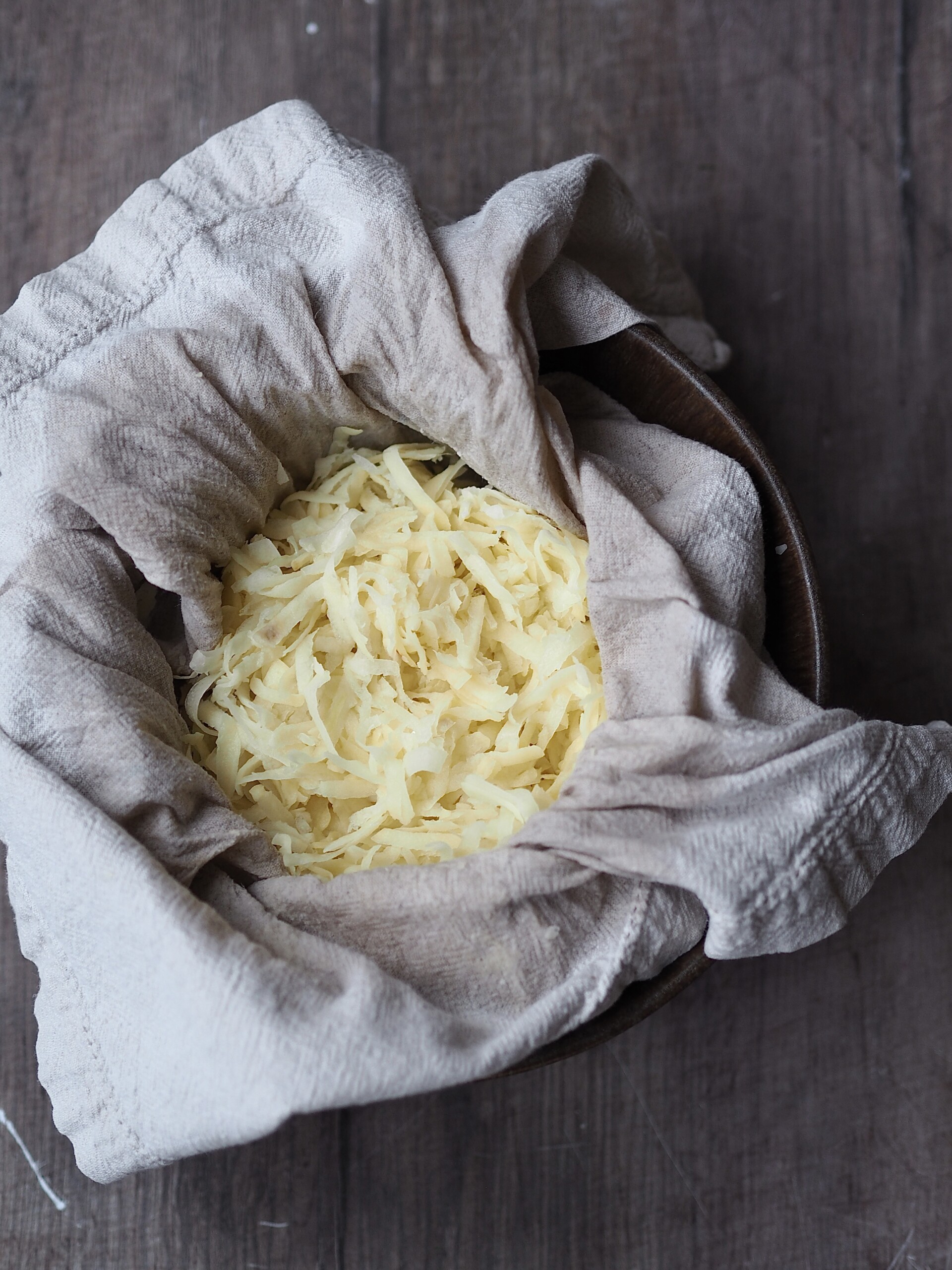 Squeezing out liquid from potatoes.