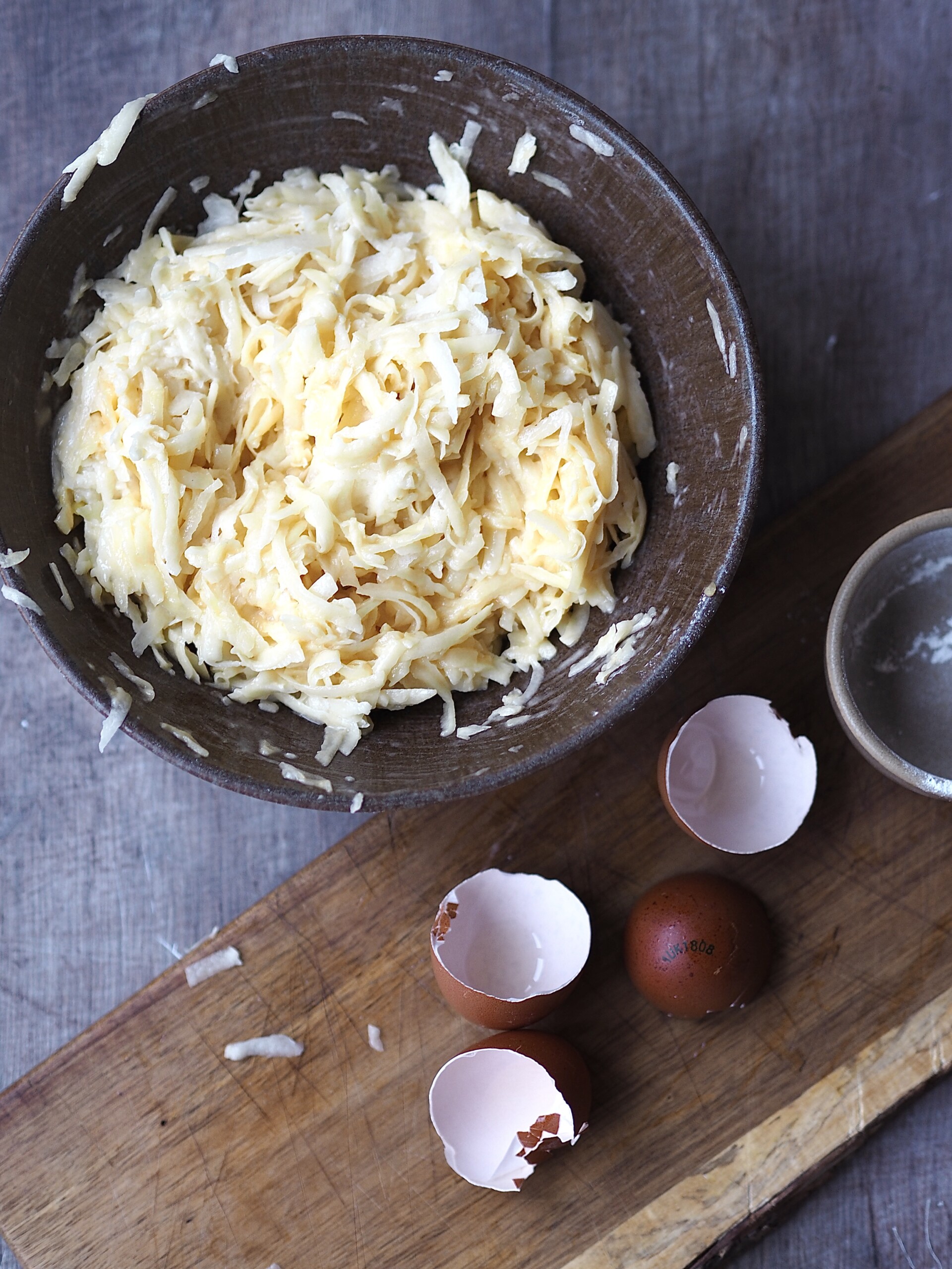 Adding eggs and flour to the potato mix