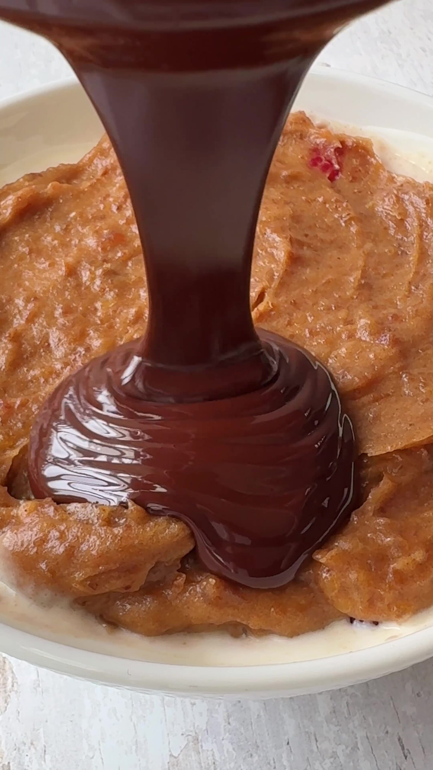 Pouring Chocolate over date caramel