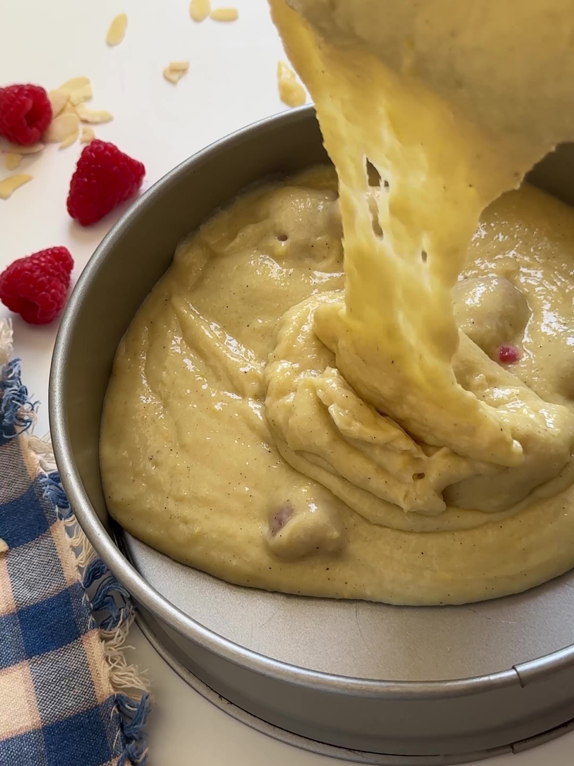 Pour batter into prepared tin layer. Top with the remaining raspberries and sprinkle with the flaked almonds.