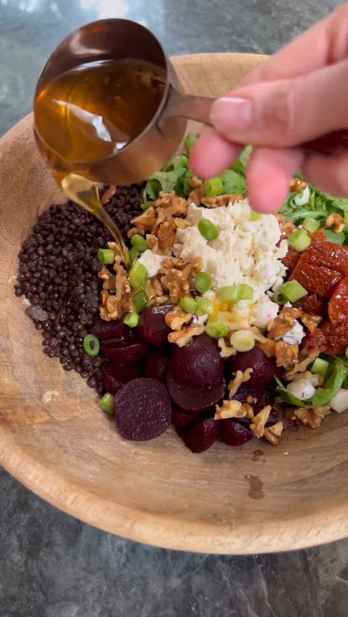 adding sundried tomato oil to the salad