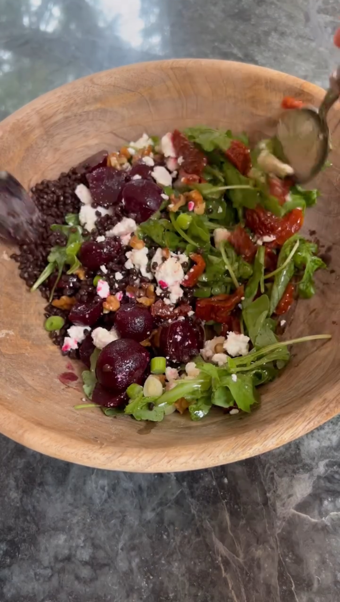 tossing the beetroot and feta salad