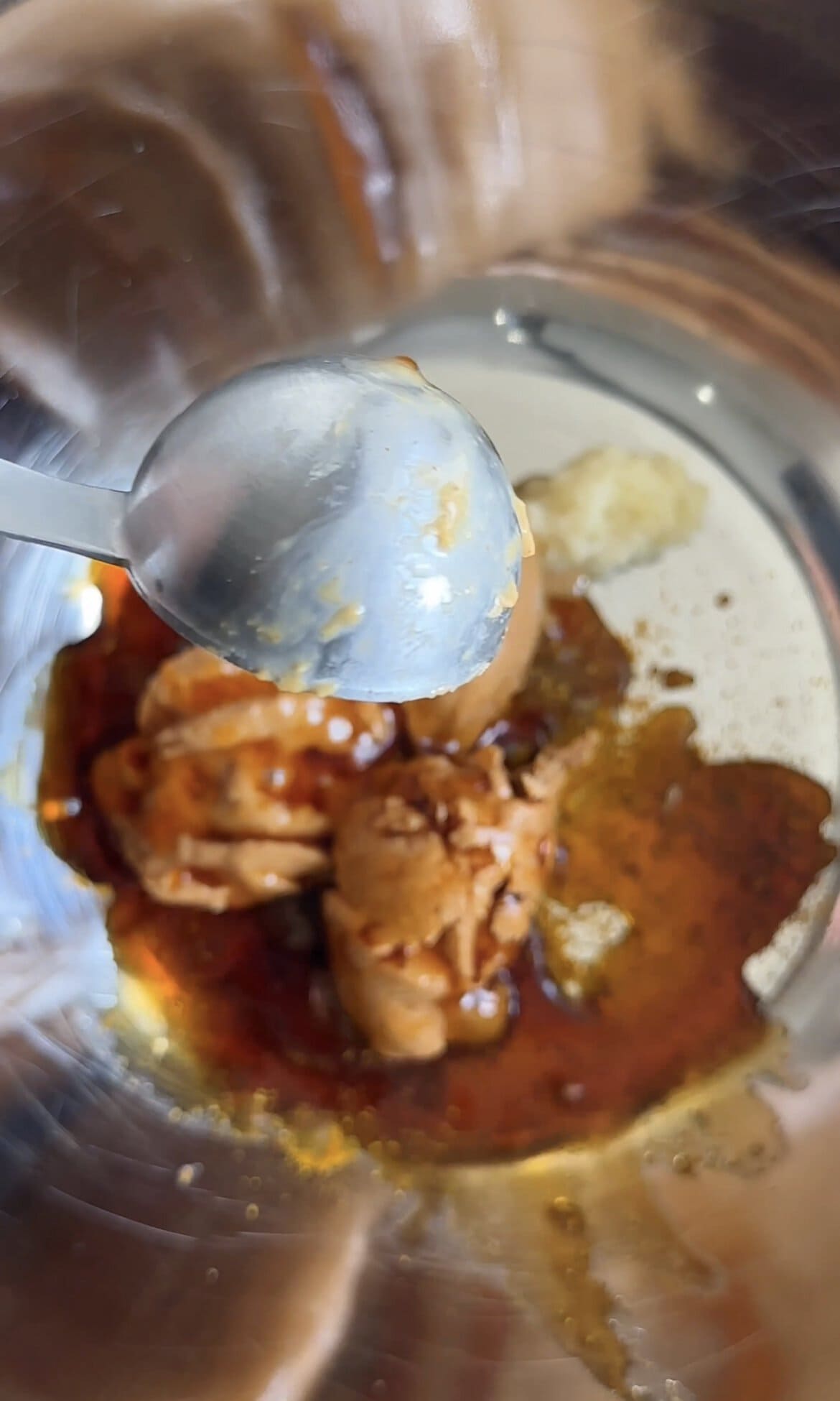 mixing chicken satay sauce to a bowl.