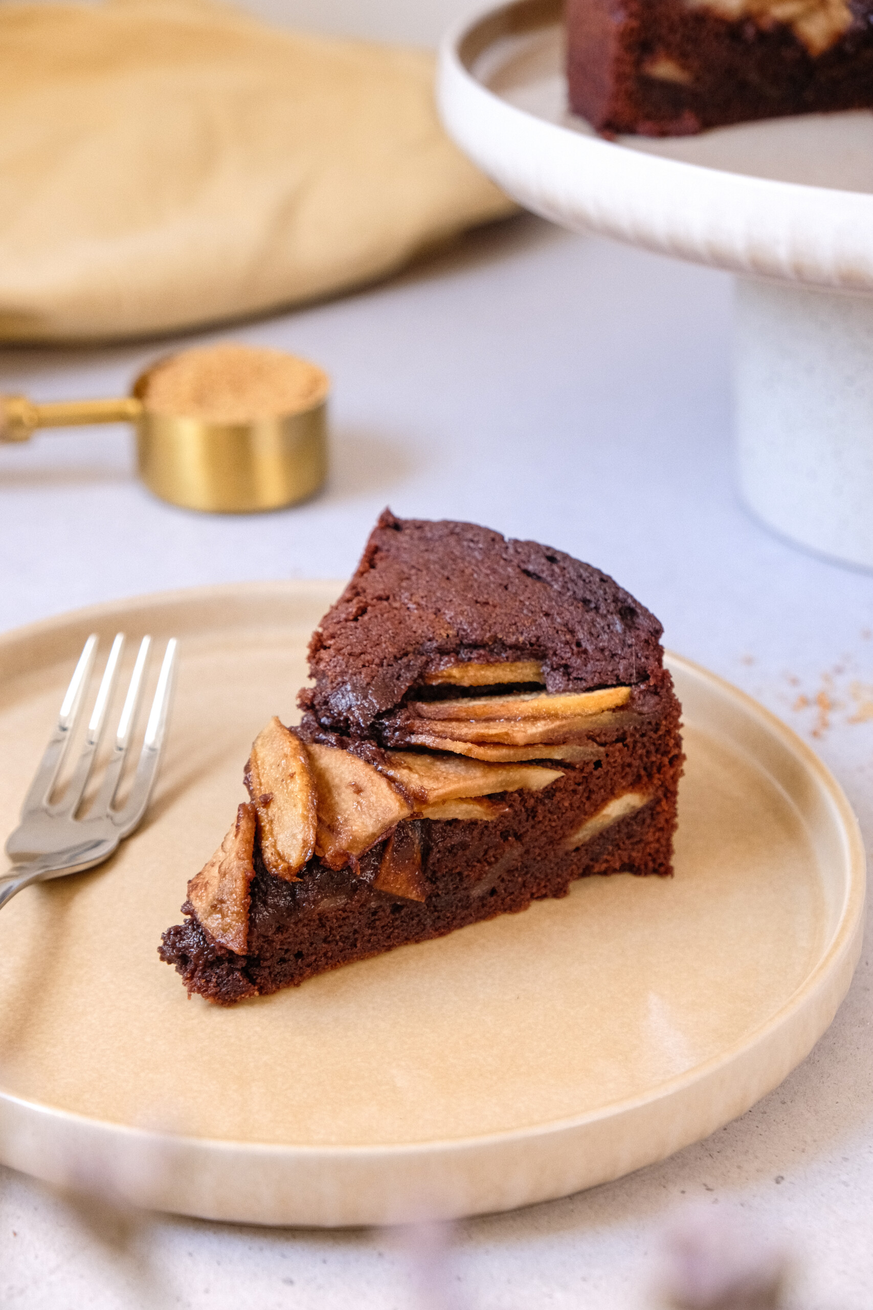 chocolate and pear cake slice on beige plate