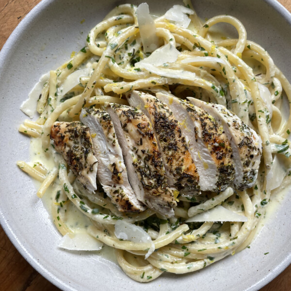 creamy chicken pasta in white bowl