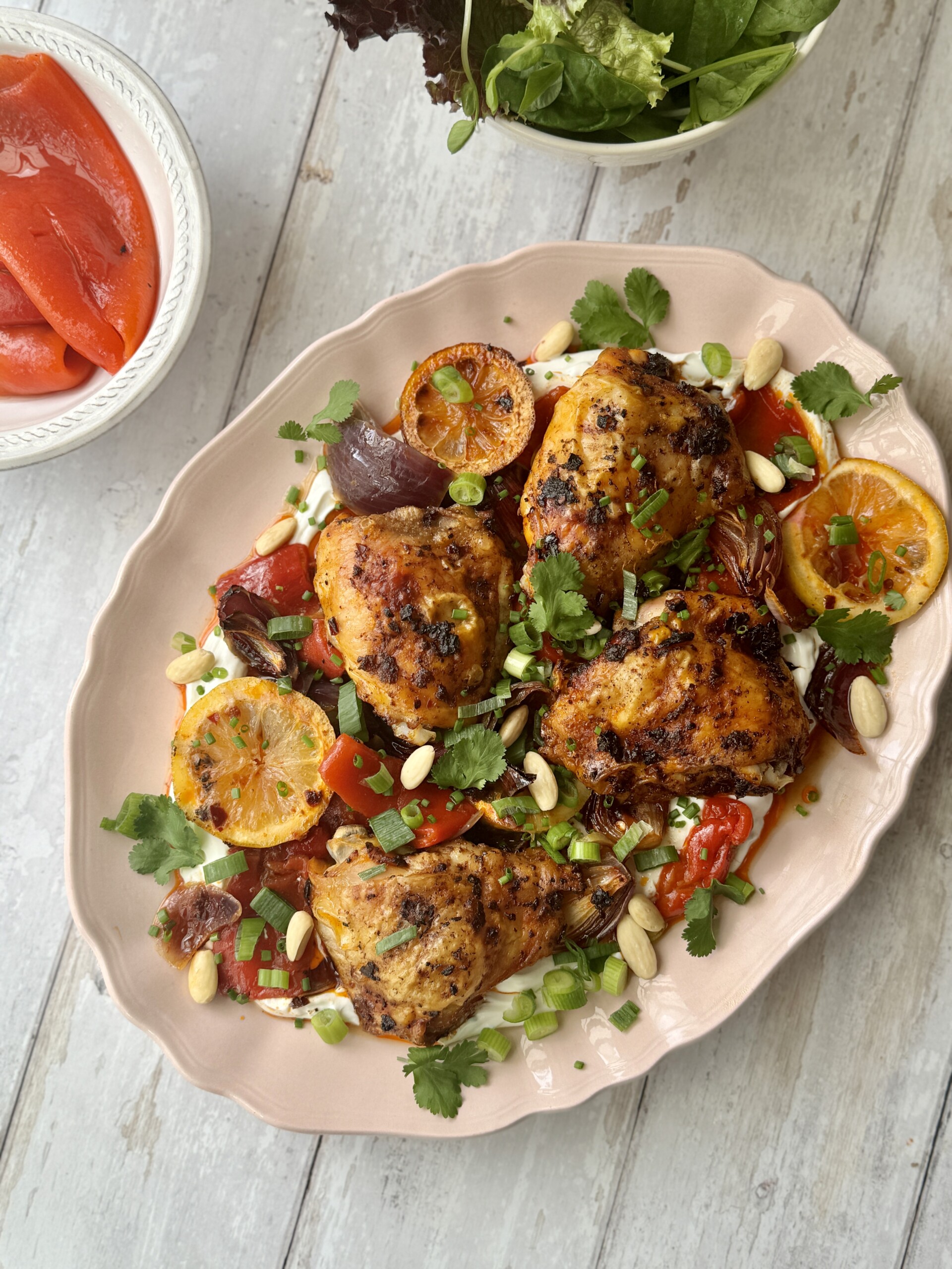 harissa chicken on platter with labneh