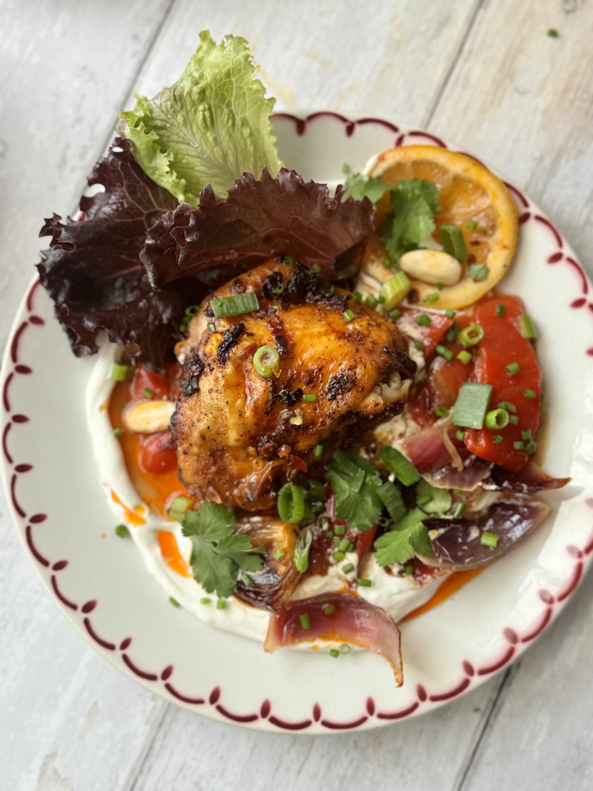 harissa chicken on platter with labneh