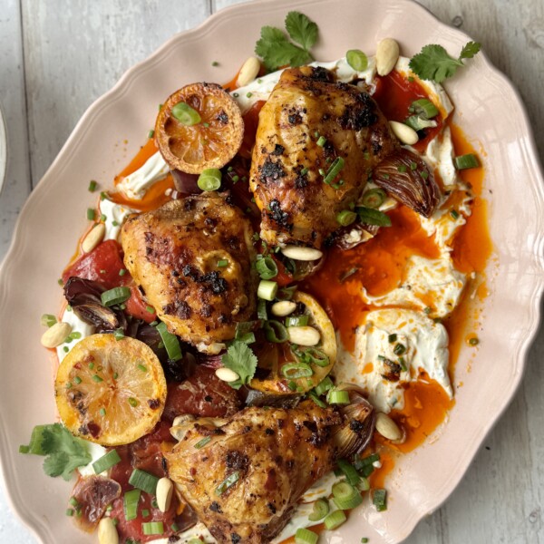 harissa chicken on platter with labneh