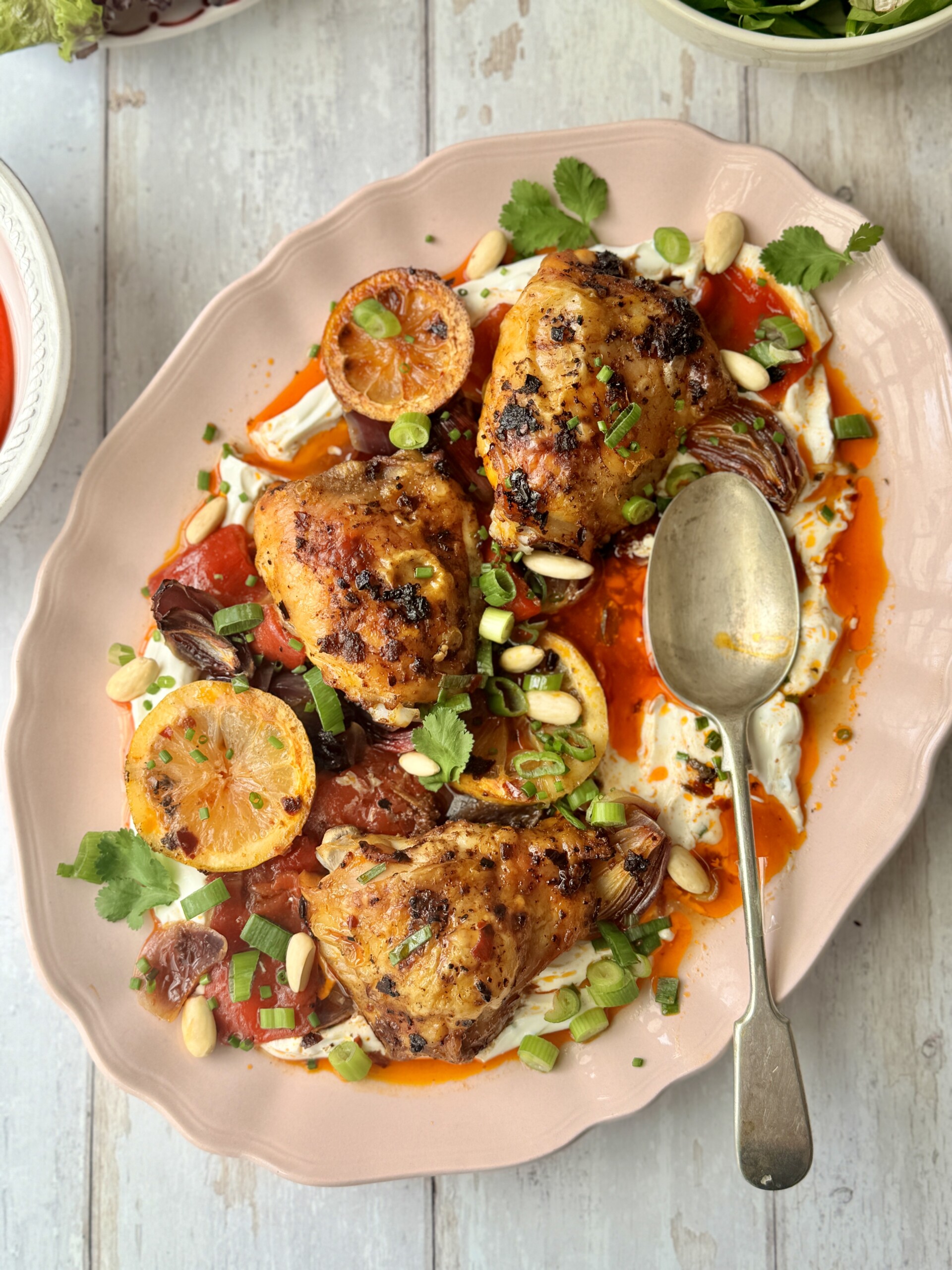 harissa chicken on platter with labneh