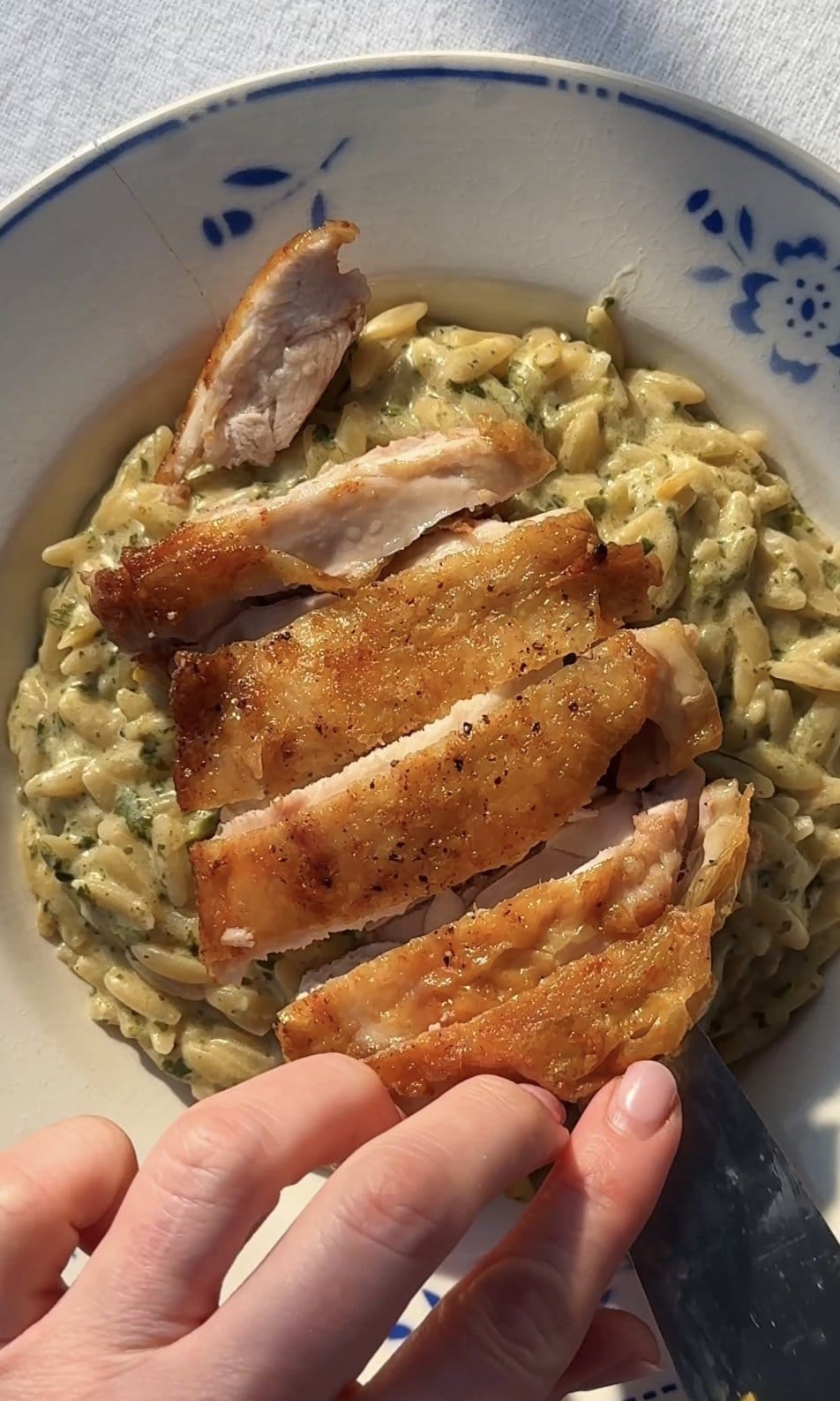 topping the lemon orzo with chicken,