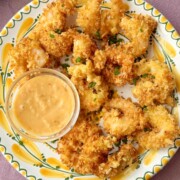 panko shrimp on a plate with dip.