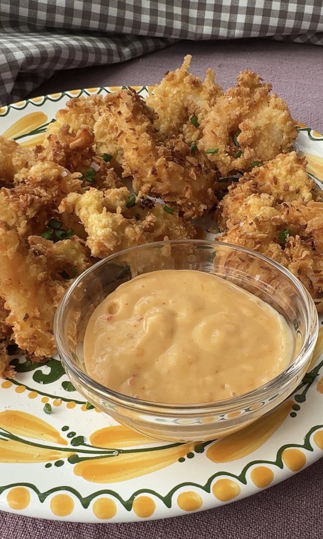 adding dipping sauce to panko shrimp.