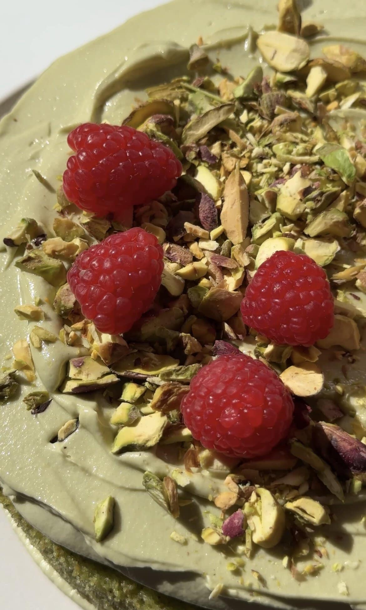 adding raspberries on top of the cake.