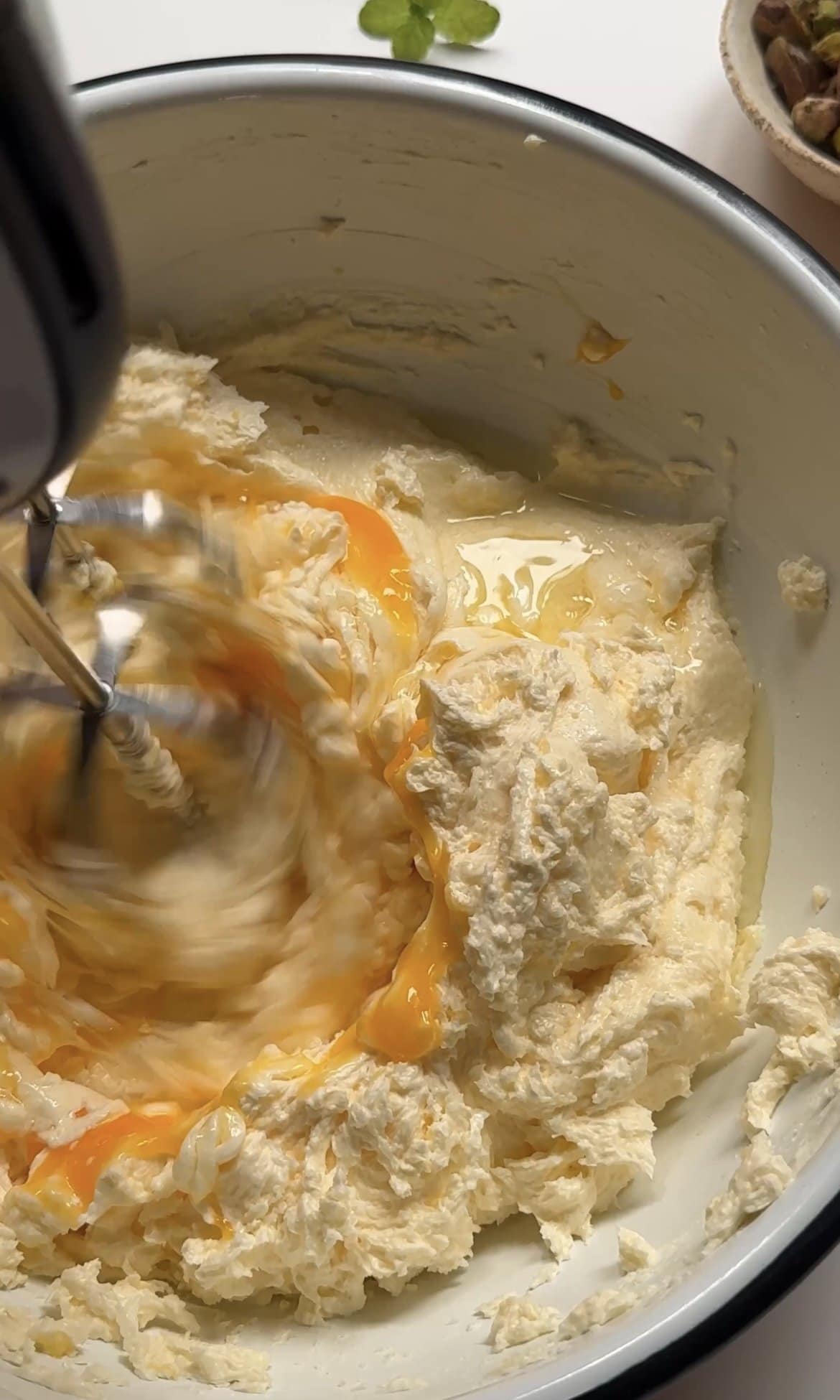 beating eggs into the cake batter.