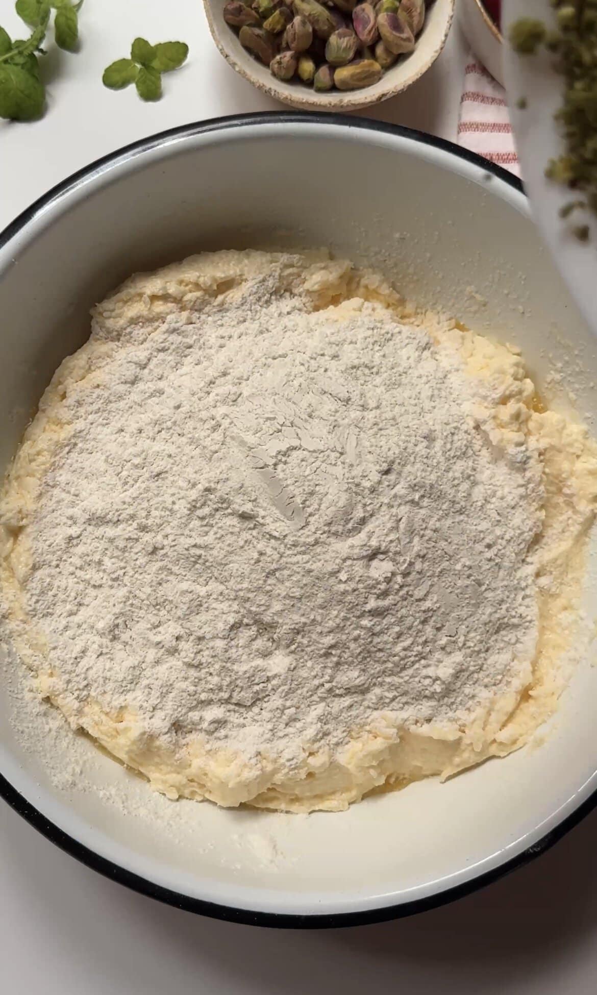 adding flour to the cake batter.