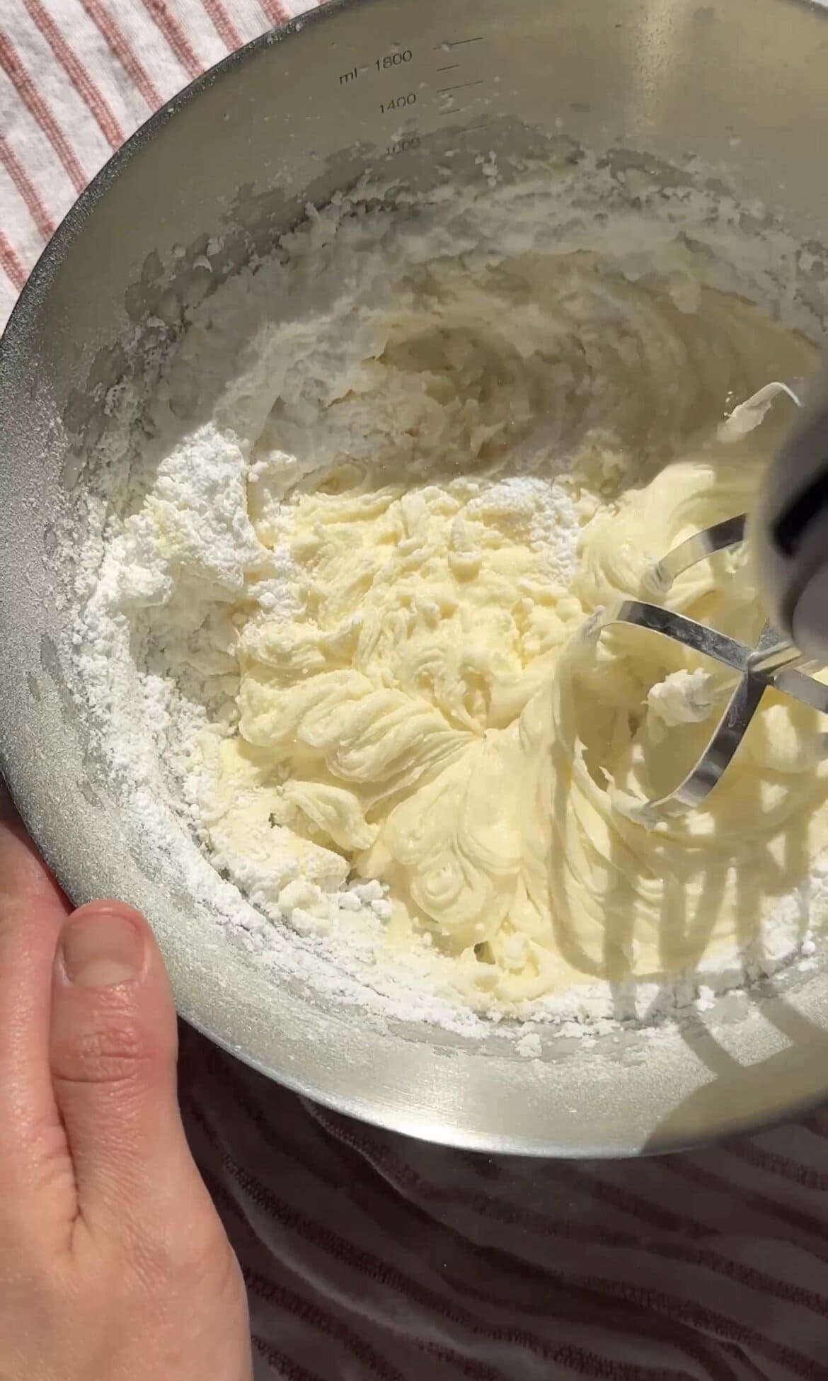 beating butter and icing sugar together.