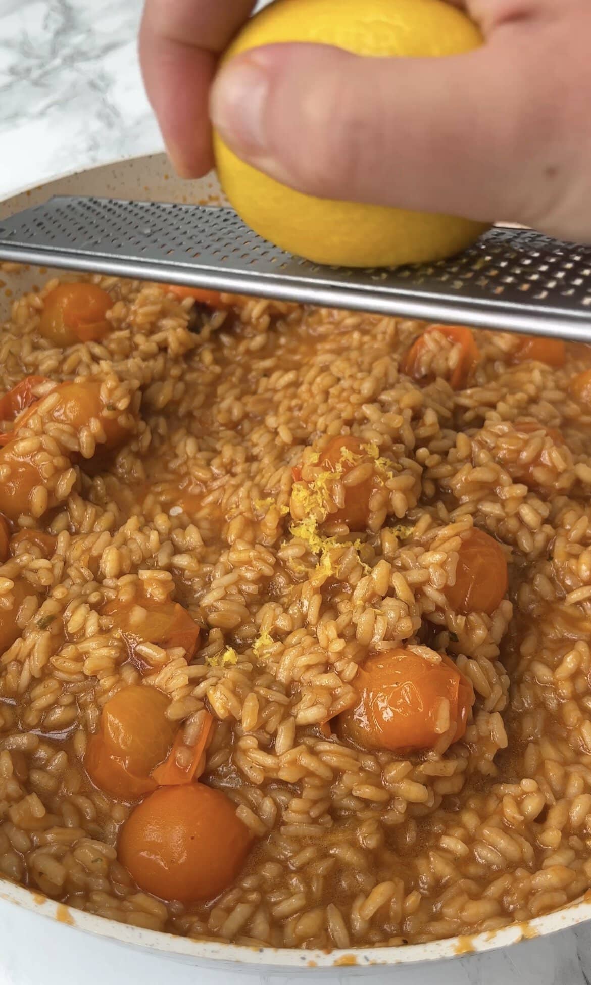 adding lemon zest to tomato mascarpone risotto