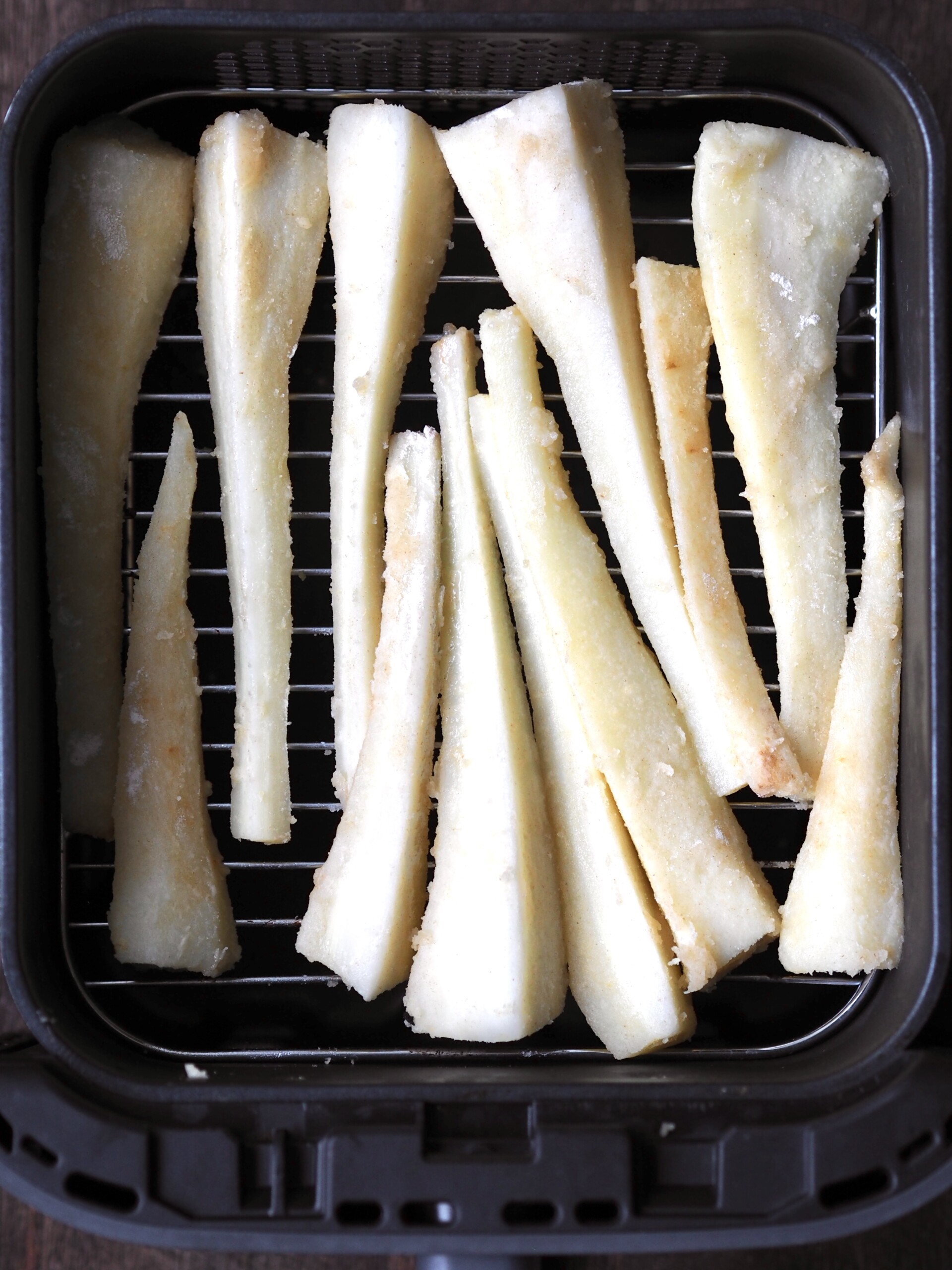 Cut parsnips in the air fryer basket.