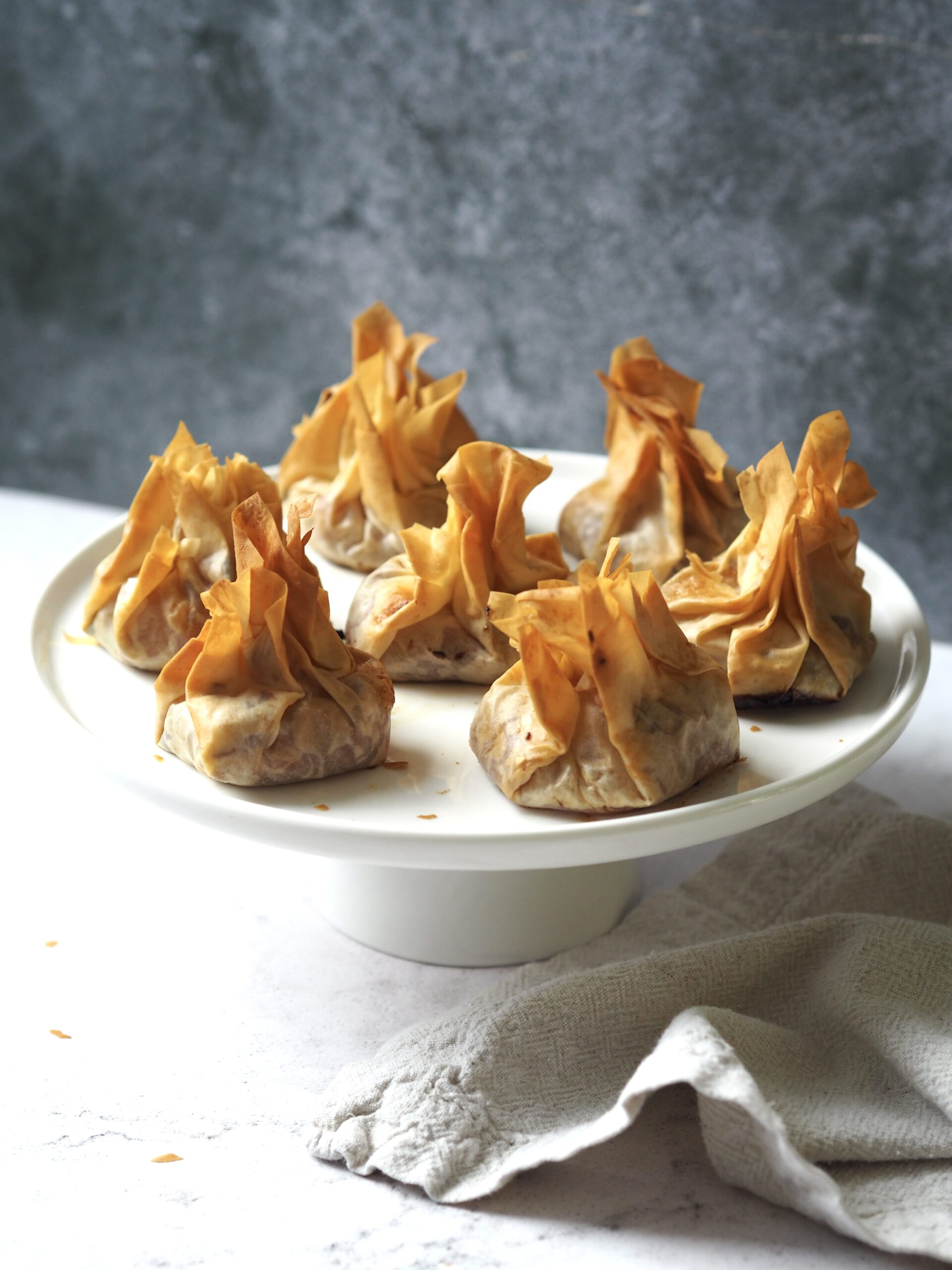 Cake stand of filo pastry parcels. 