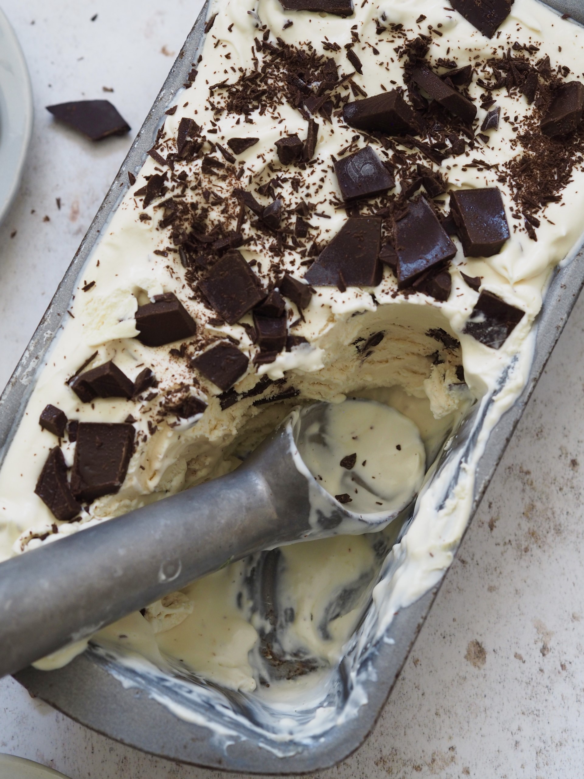 Scooping ice cream from baking tin.