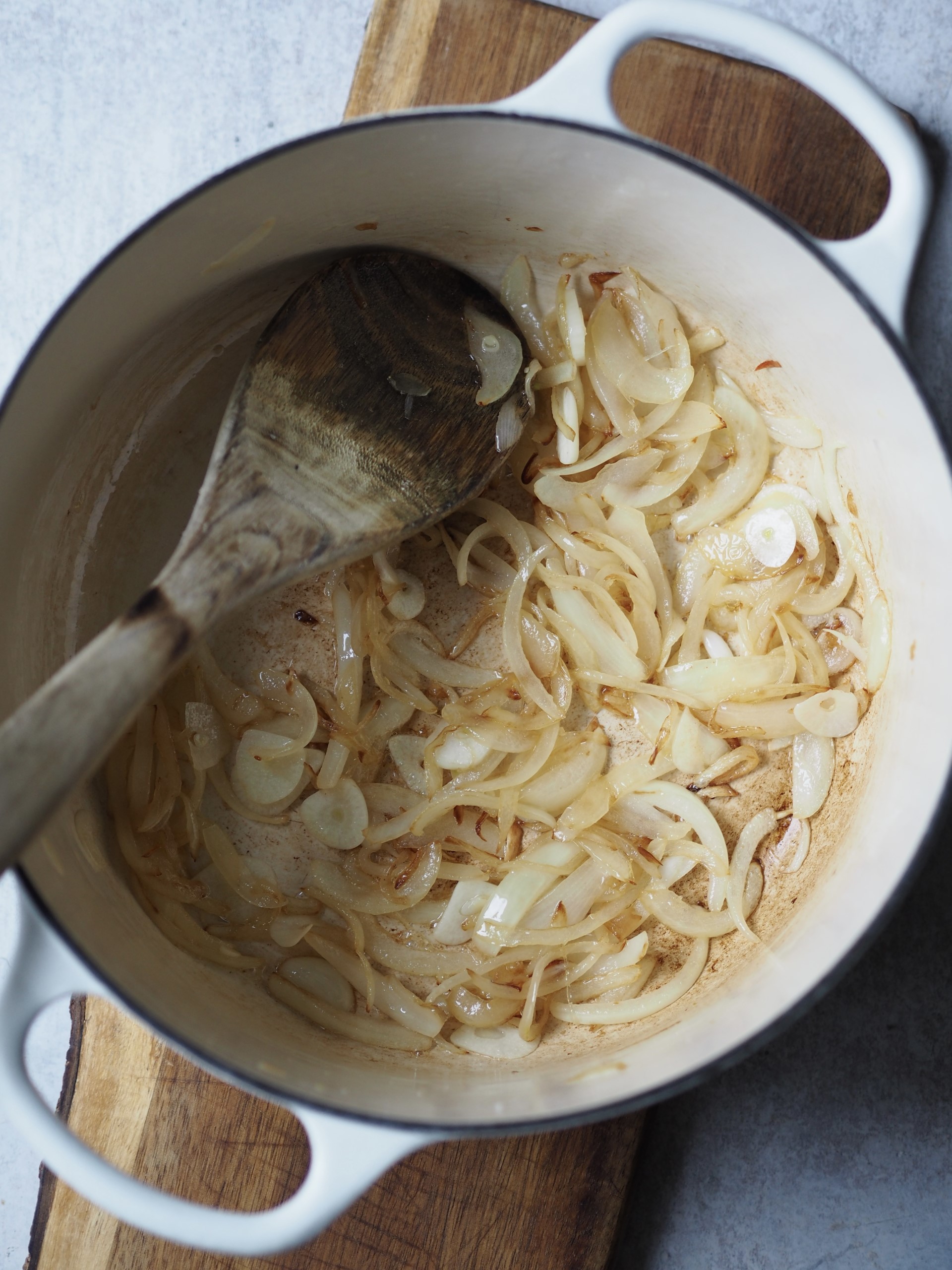 Adding onions to a pan 