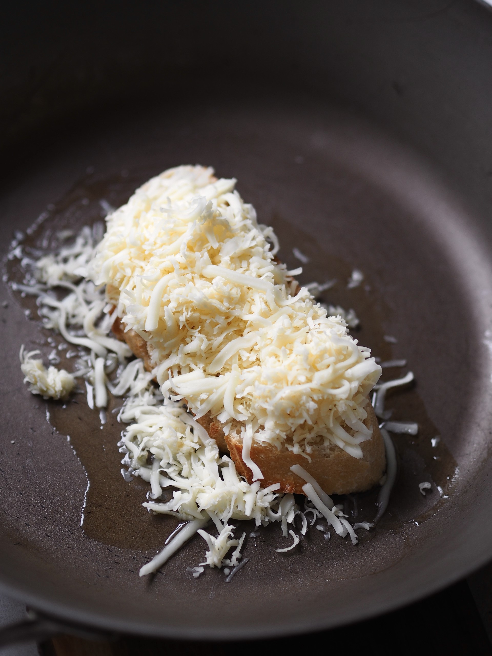 Topping bread with cheese and grilling