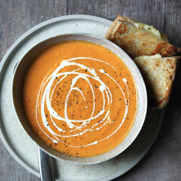 Serving tomato Soup with Grilled Cheese sandwich