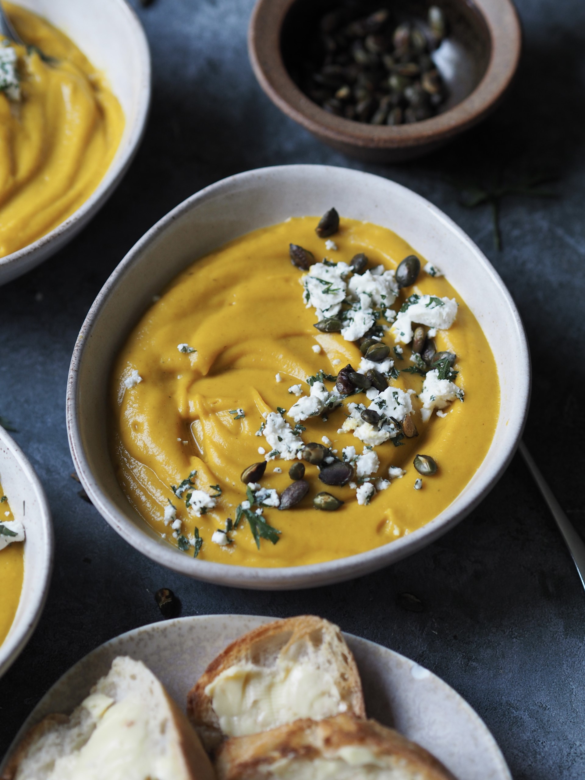 Serving Spiced Carrot and Lentil Soup with Feta Crumble