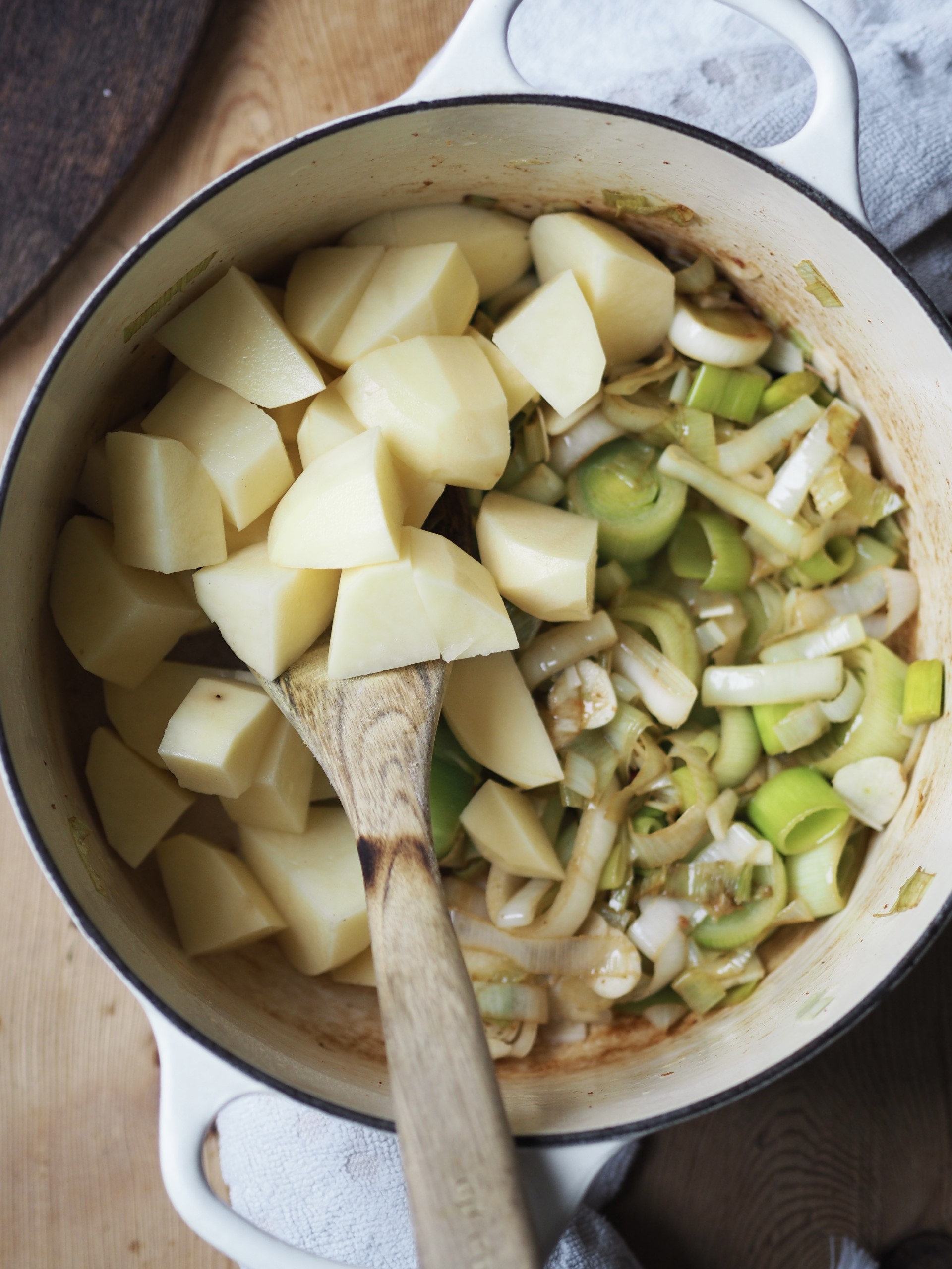 Adding potatoes to the pan