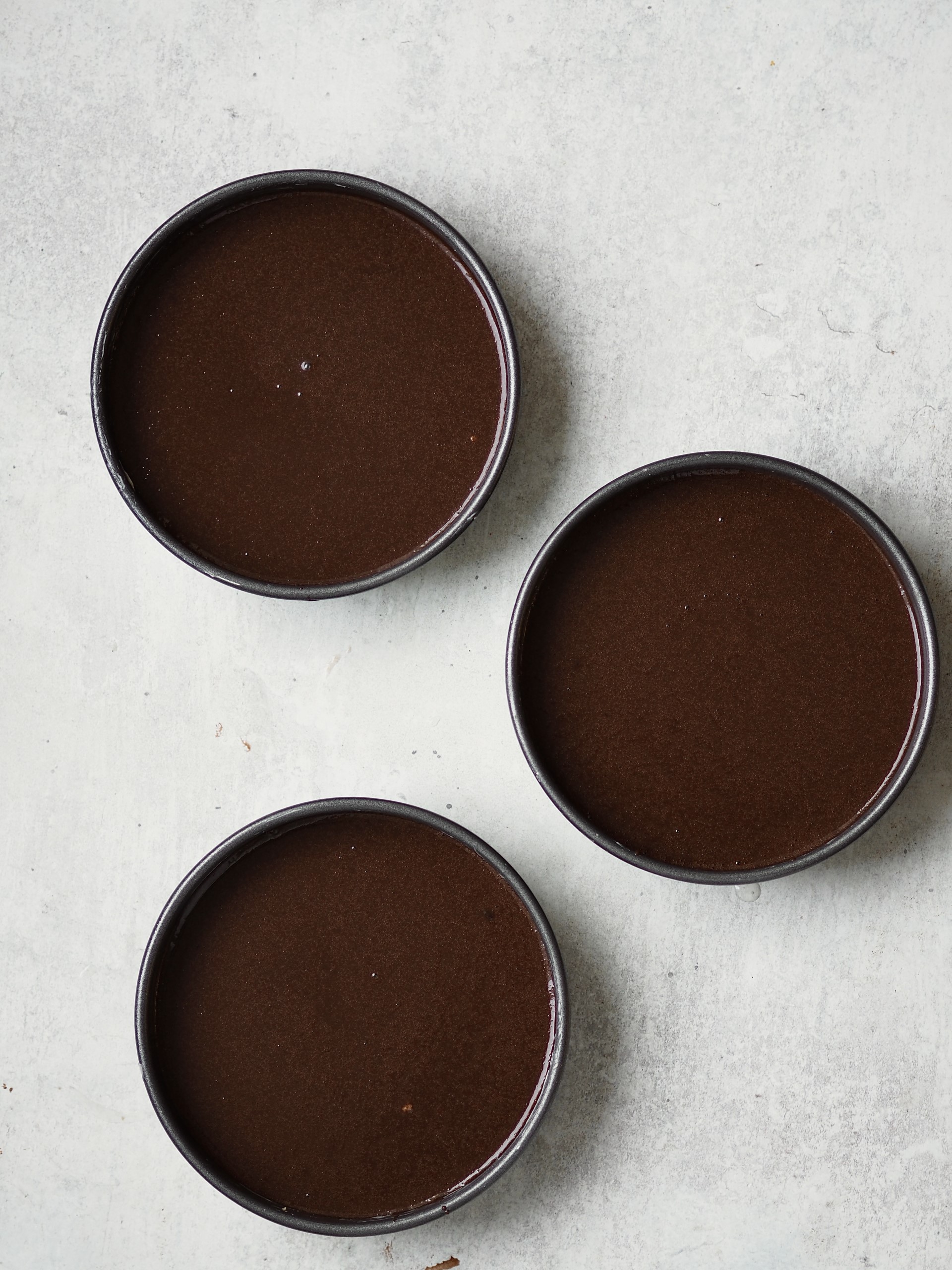 Pouring batter into baking tins.