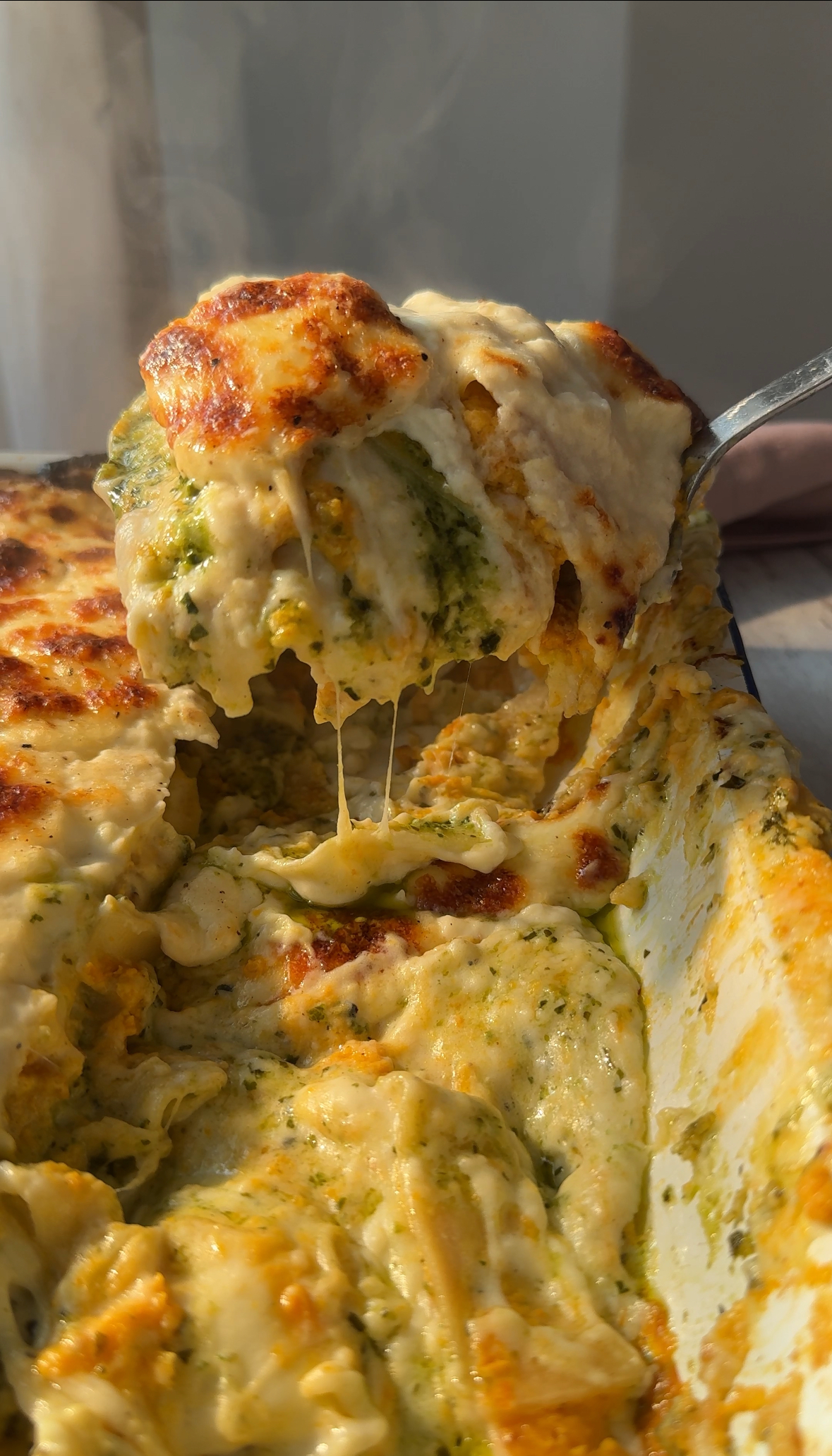 slicing into pesto lasagne with butternut squash