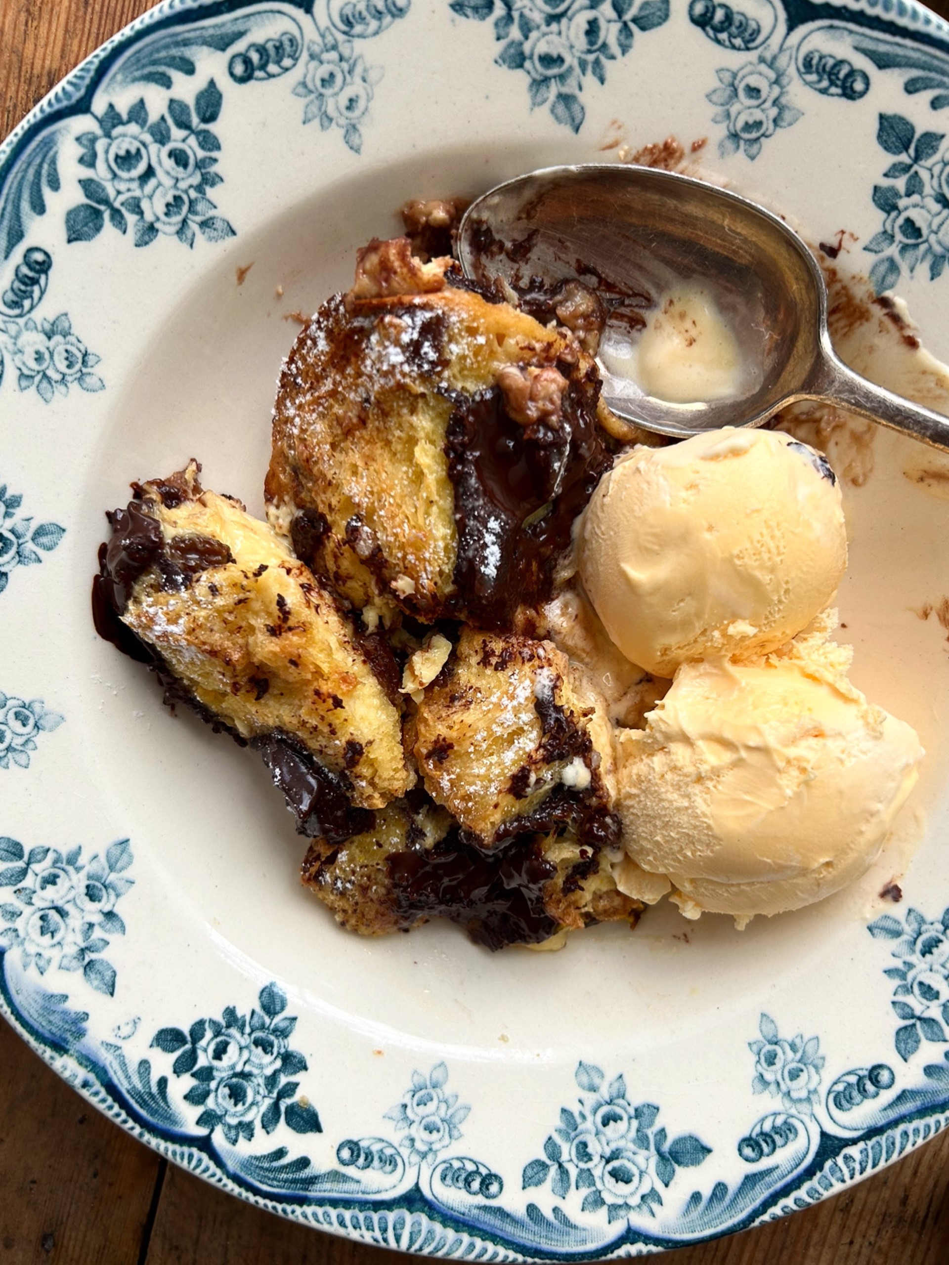 Panettone, Orange and Dark Chocolate Bread and Butter Pudding in a bowl with ice cream