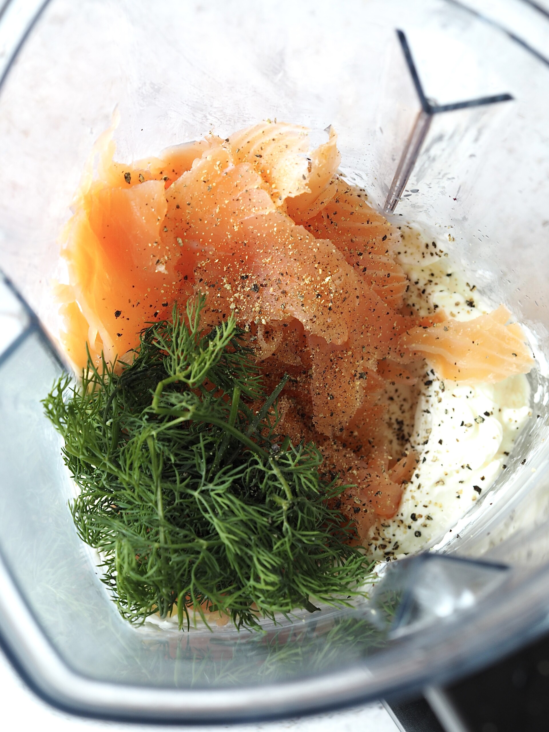 Smoked salmon, dill, black pepper and cream cheese in the bottom of a blender.