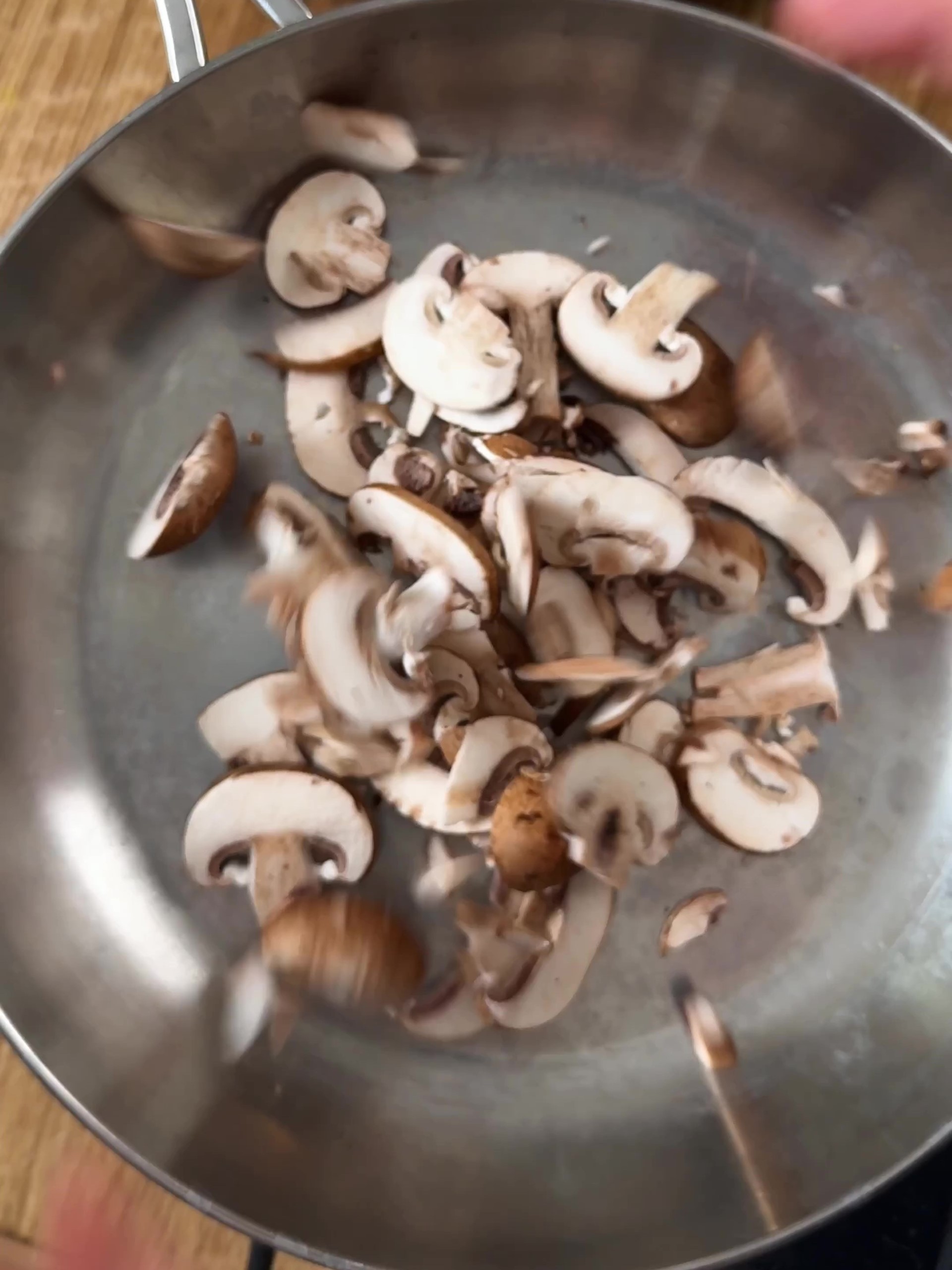 Adding mushrooms to a pan