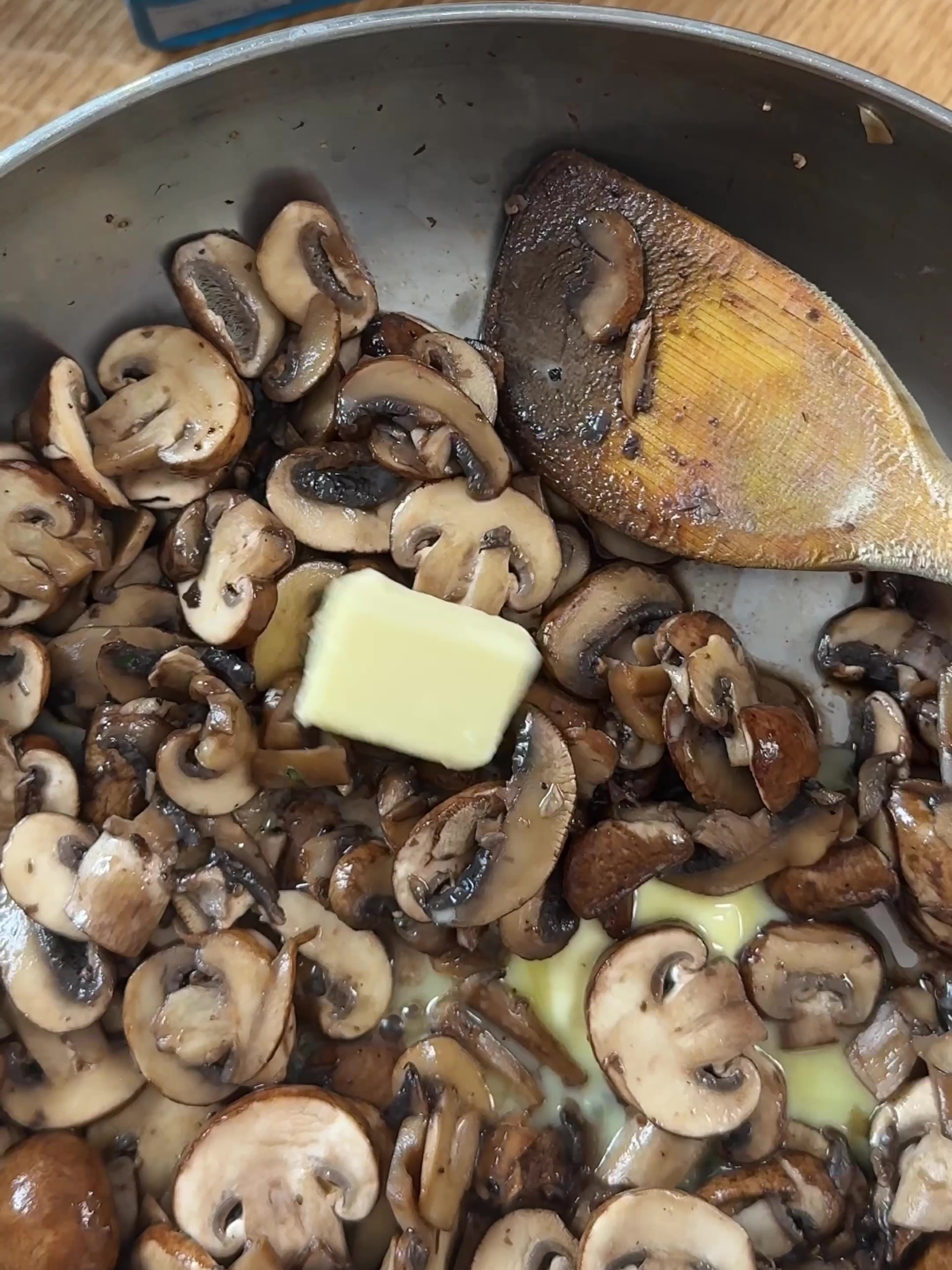 Adding butter to the mushrooms