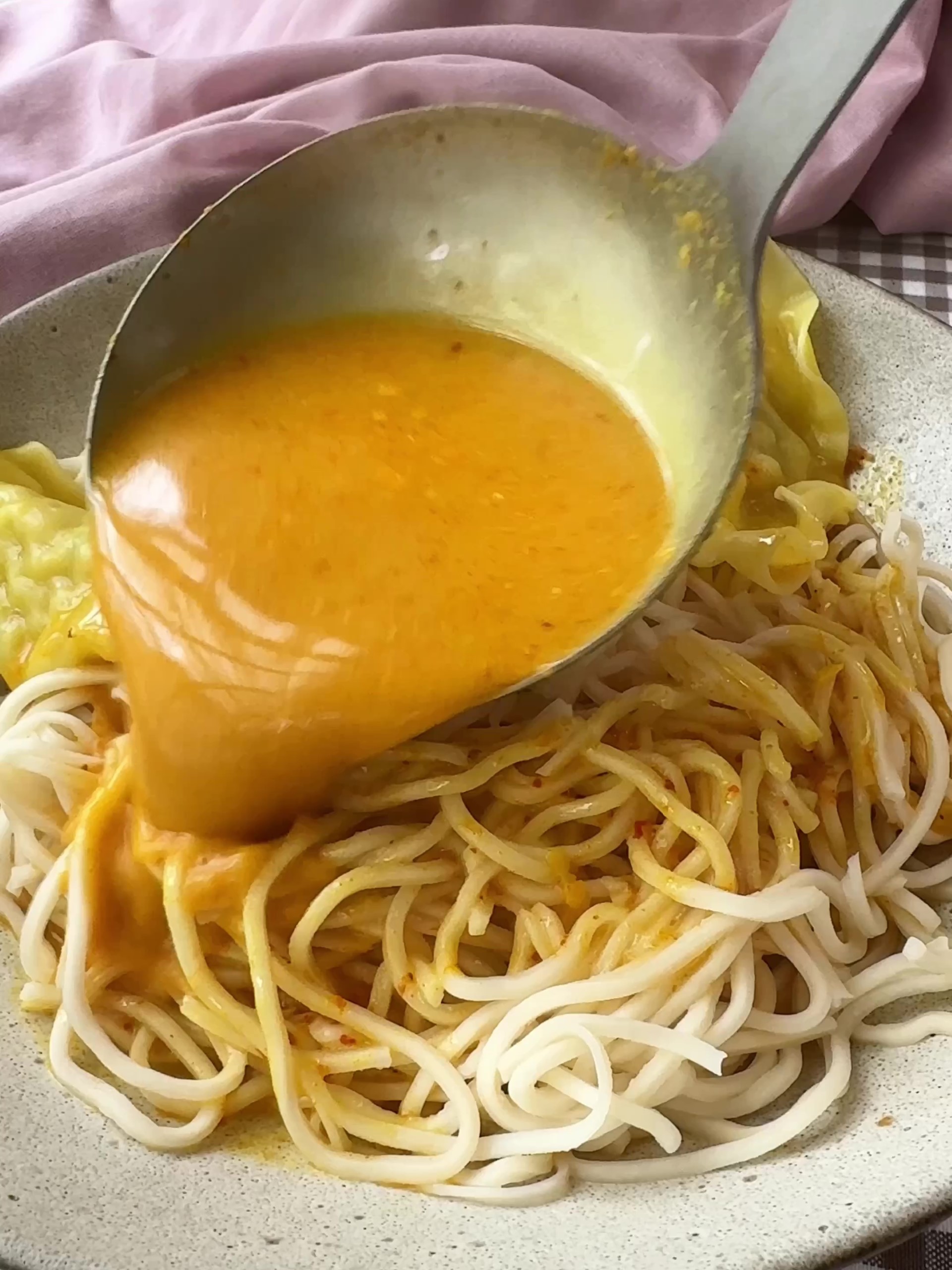 Pouring broth over noodles