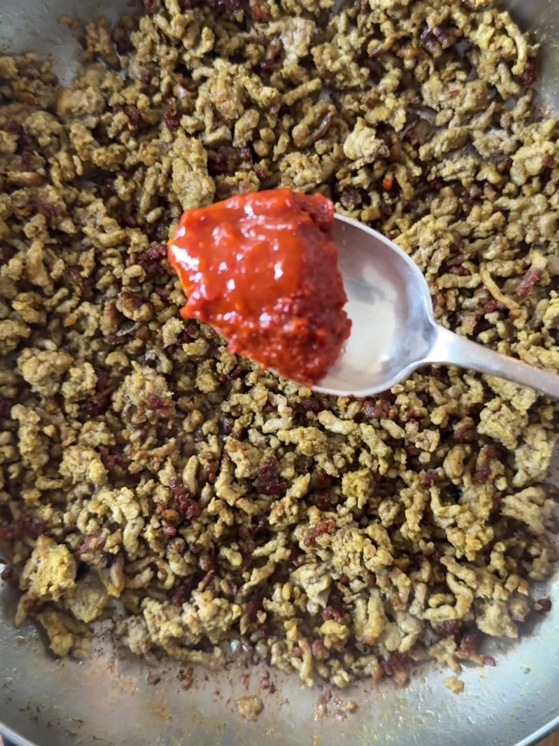 Stirring in harissa paste