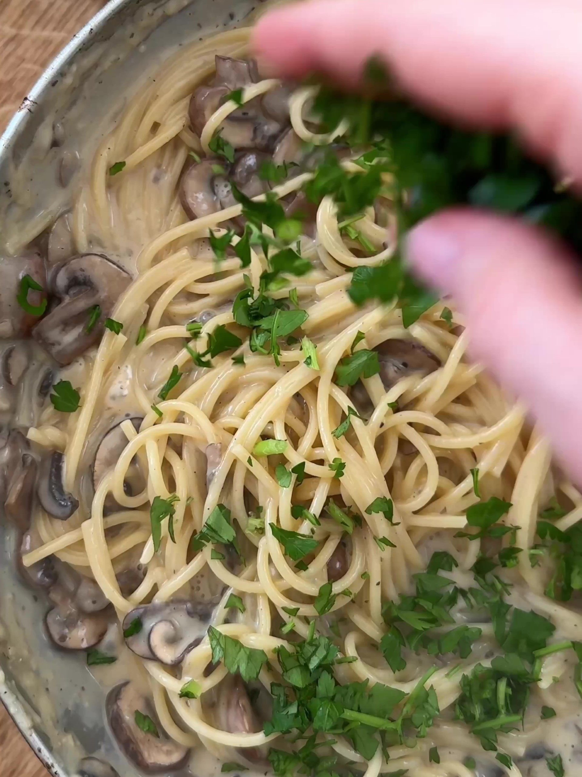 Adding parsley to the pasta