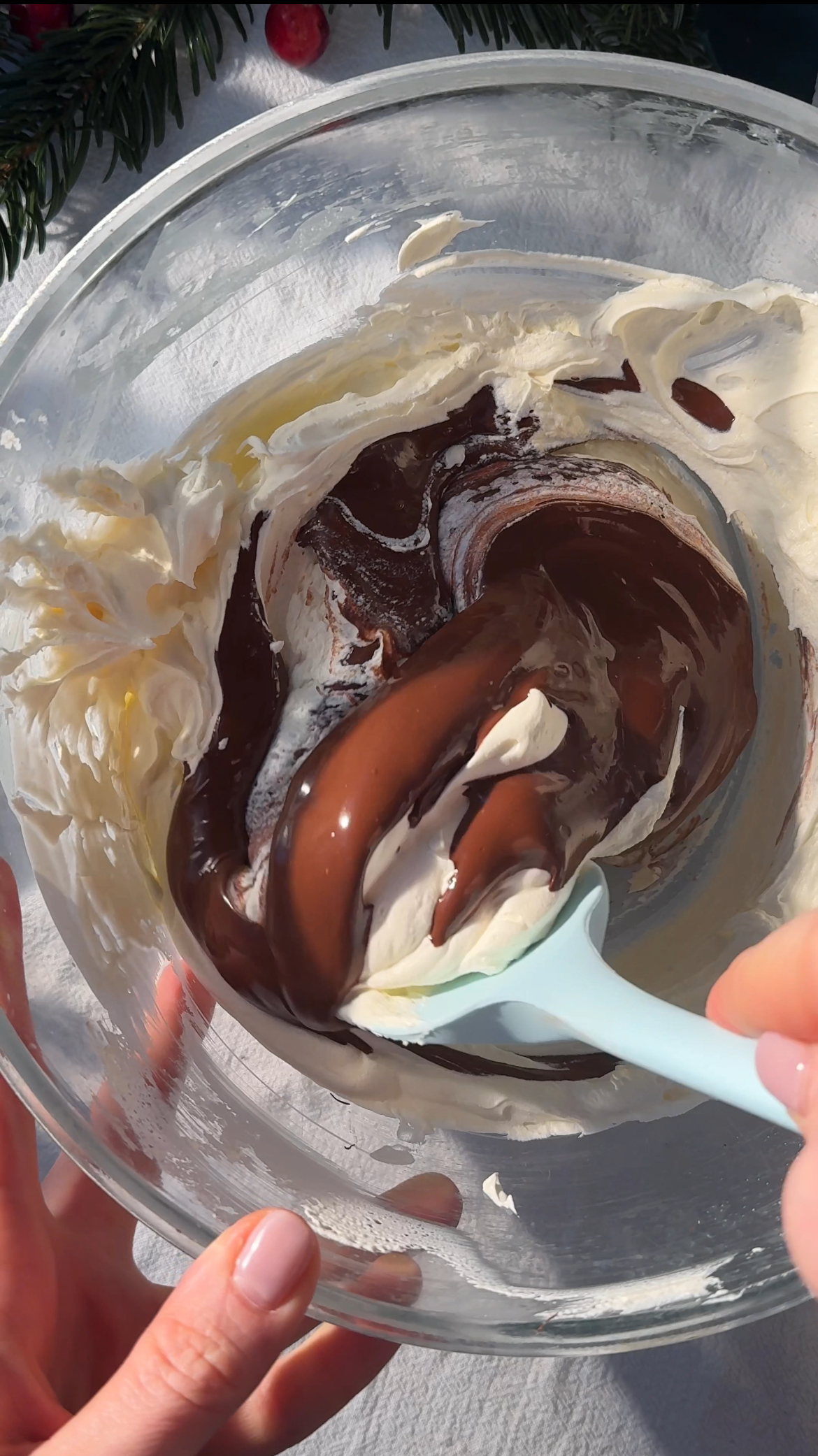 folding melted chocolate into cream.