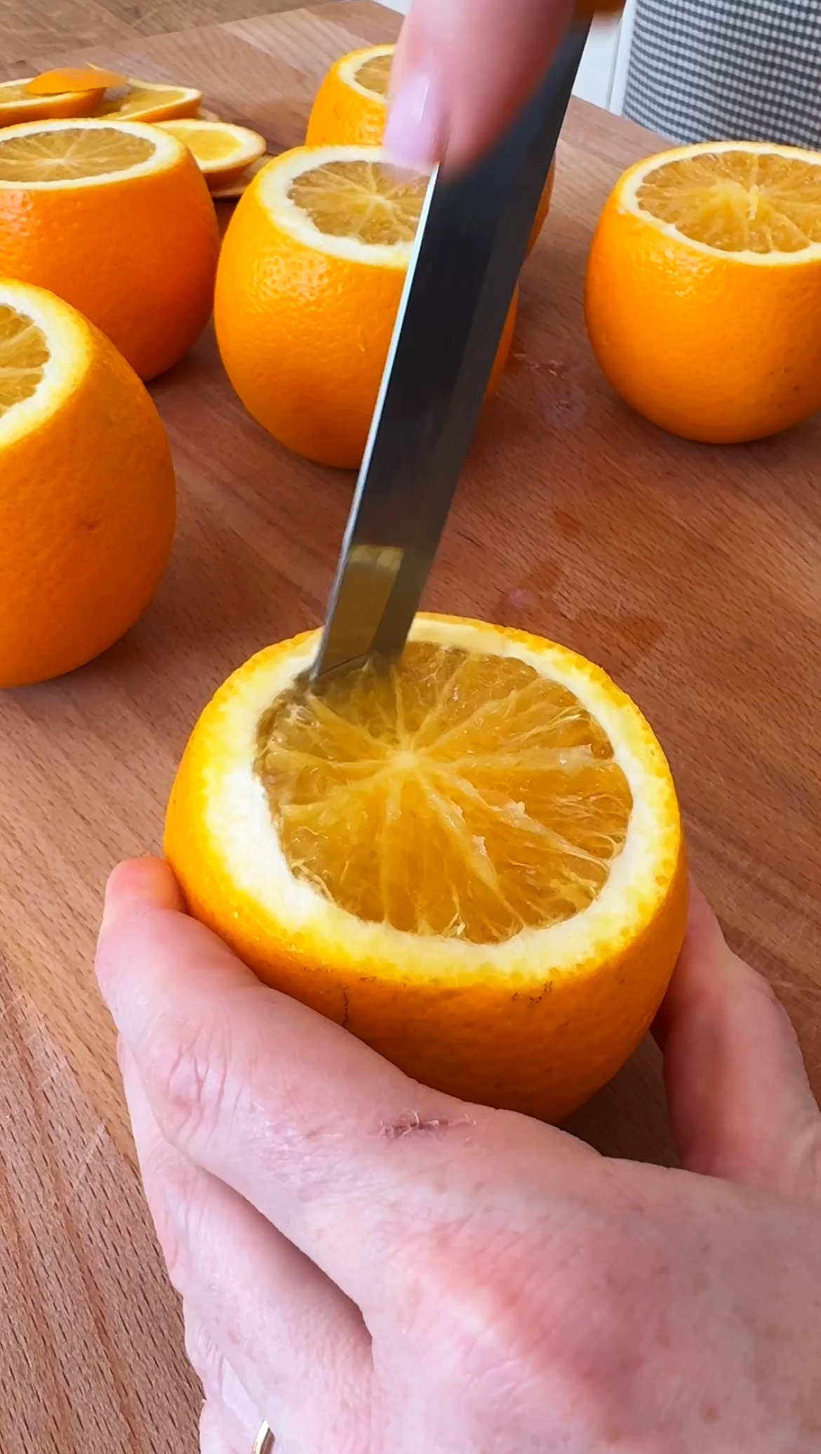 scooping the orange halves