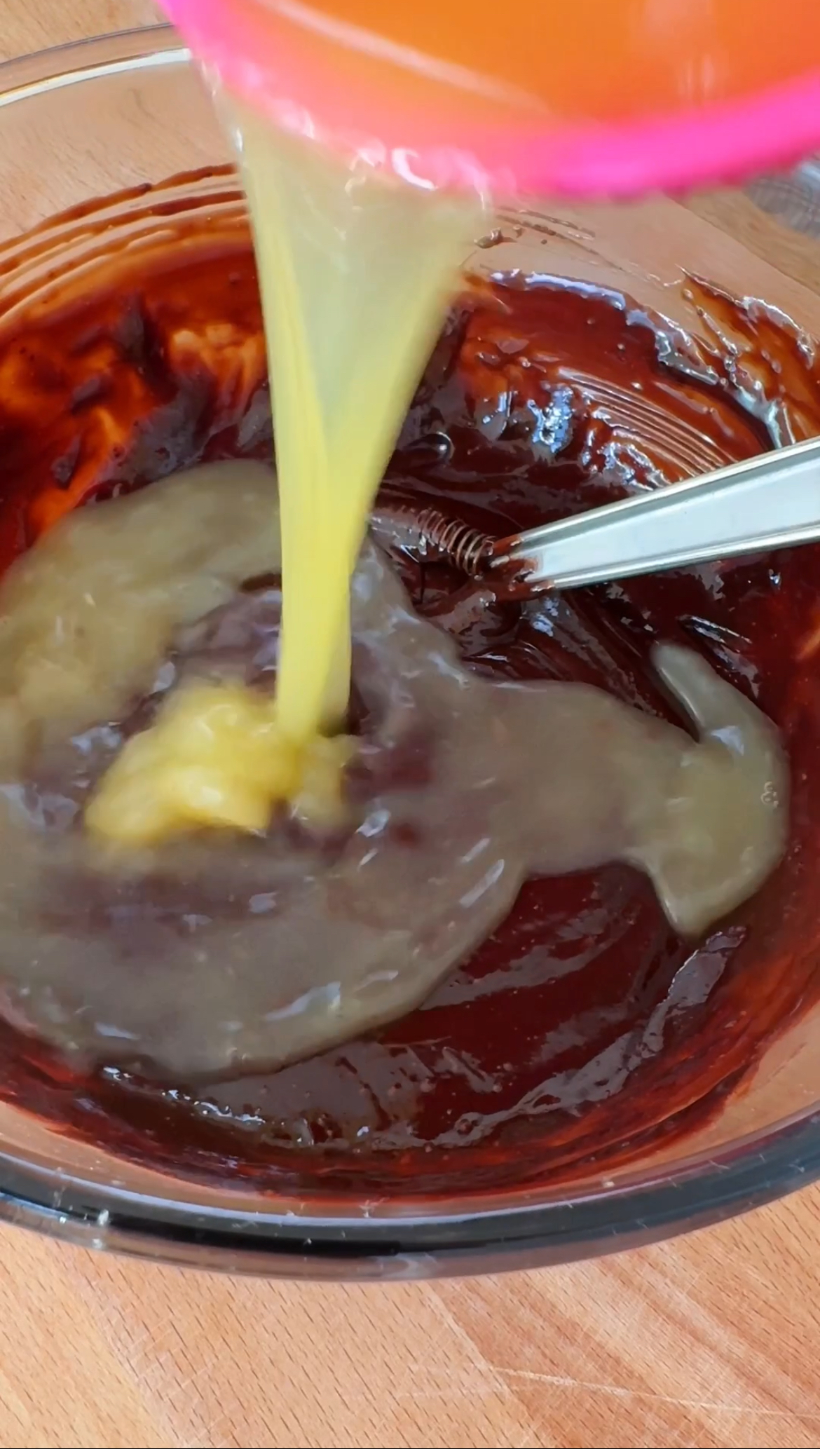 adding orange juice to melted chocolate