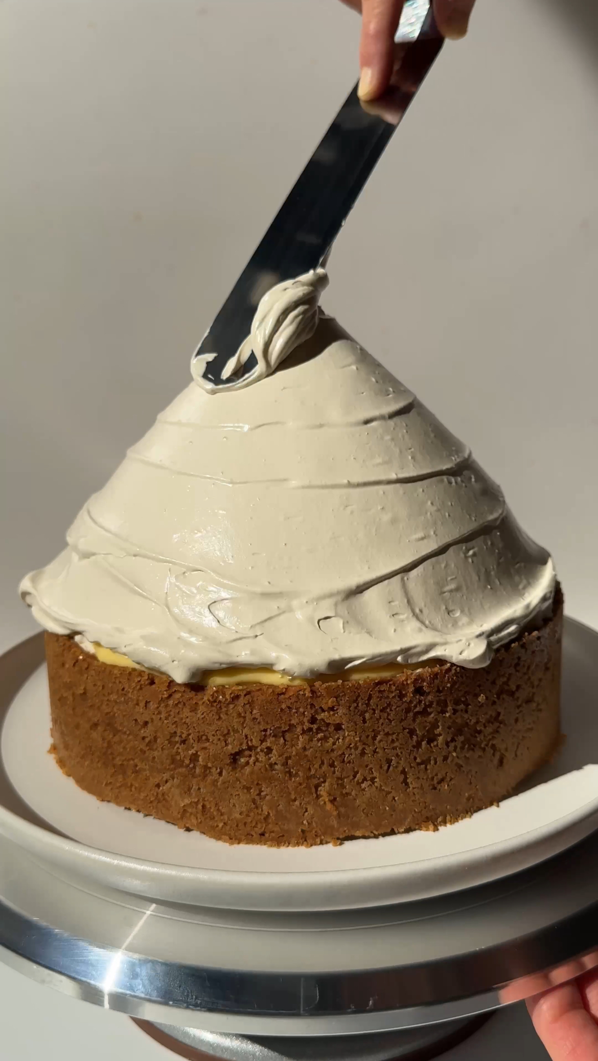 smoothing meringue onto the cheesecake