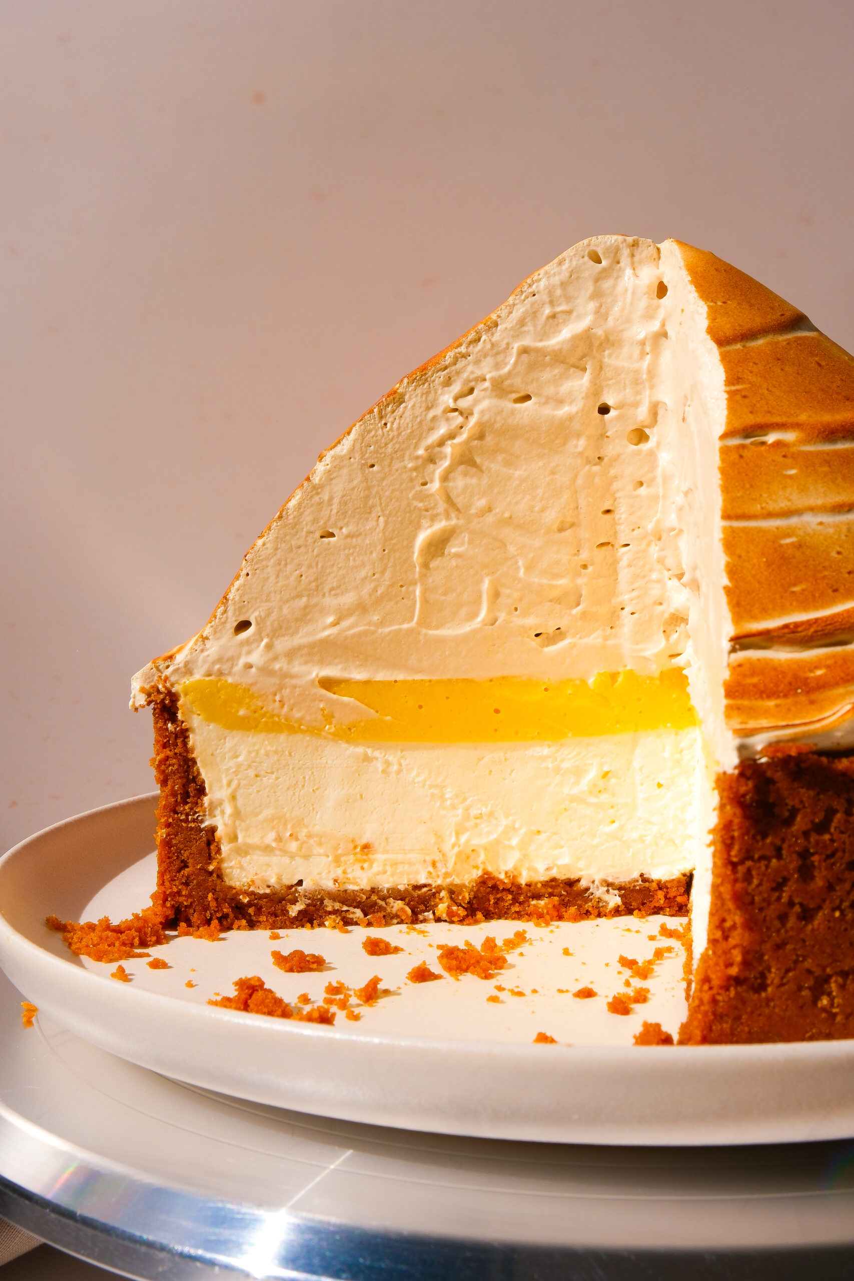 slice removed from lemon meringue cheesecake