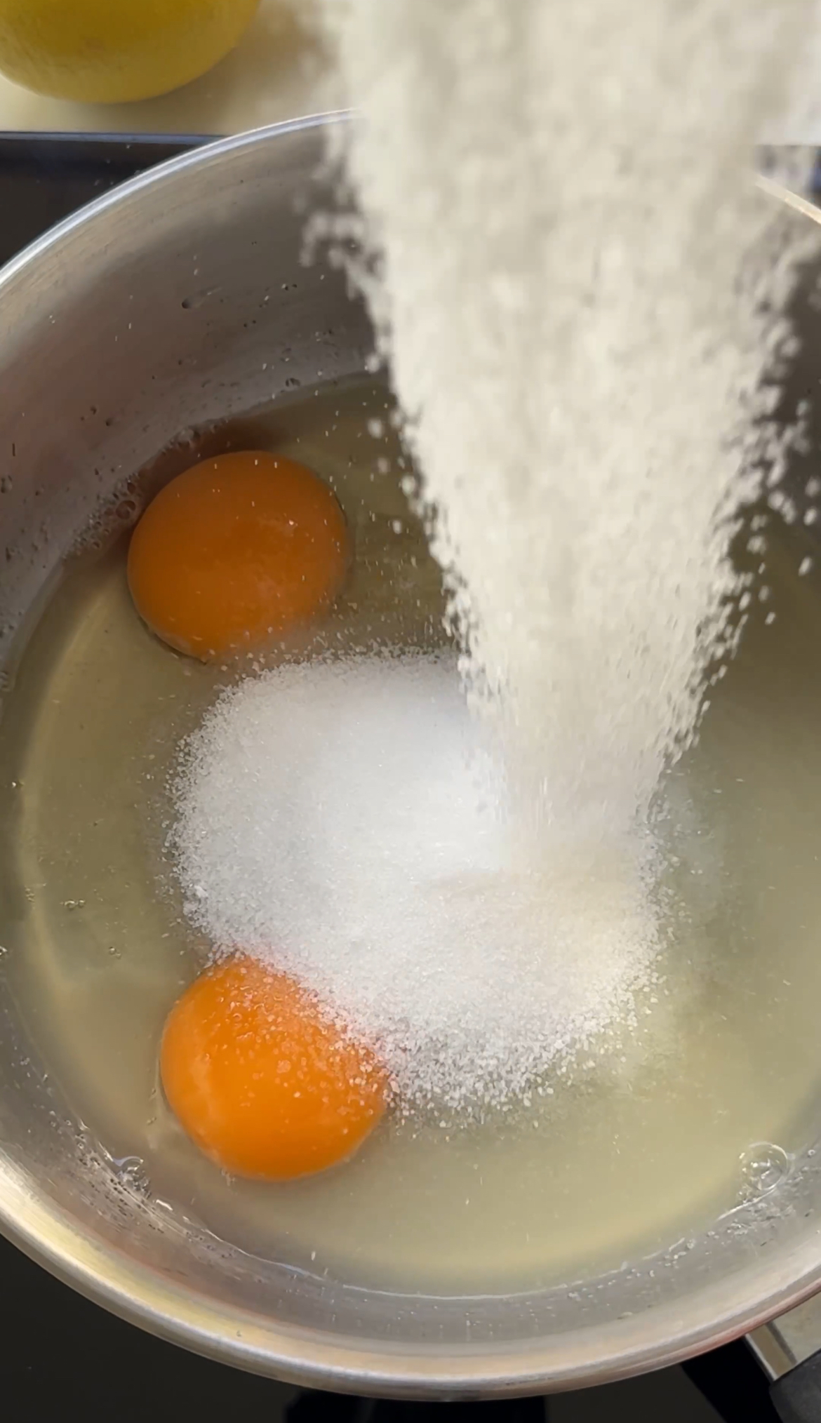 adding sugar to the lemon curd